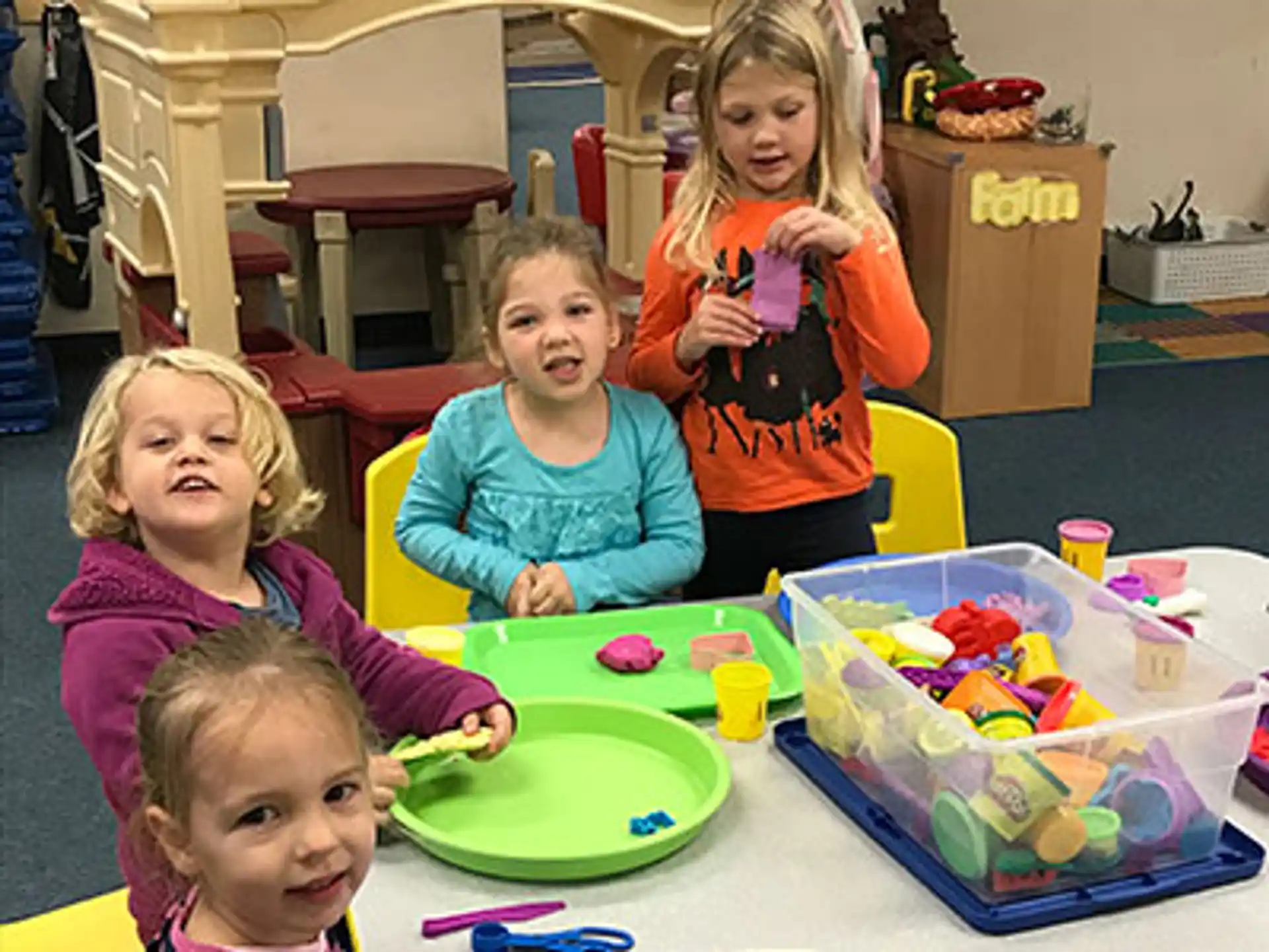 a group of children sitting at a table