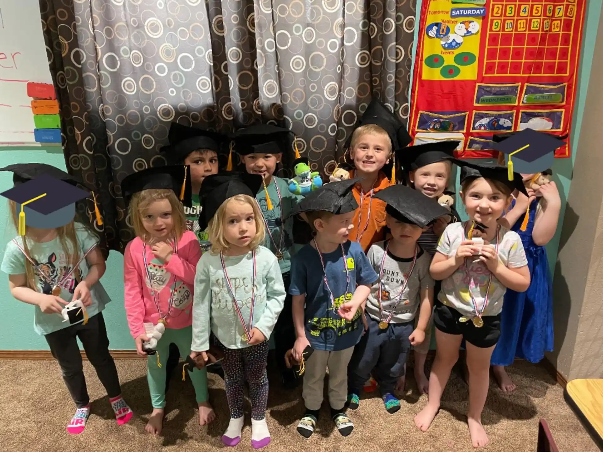 a group of children wearing graduation hats
