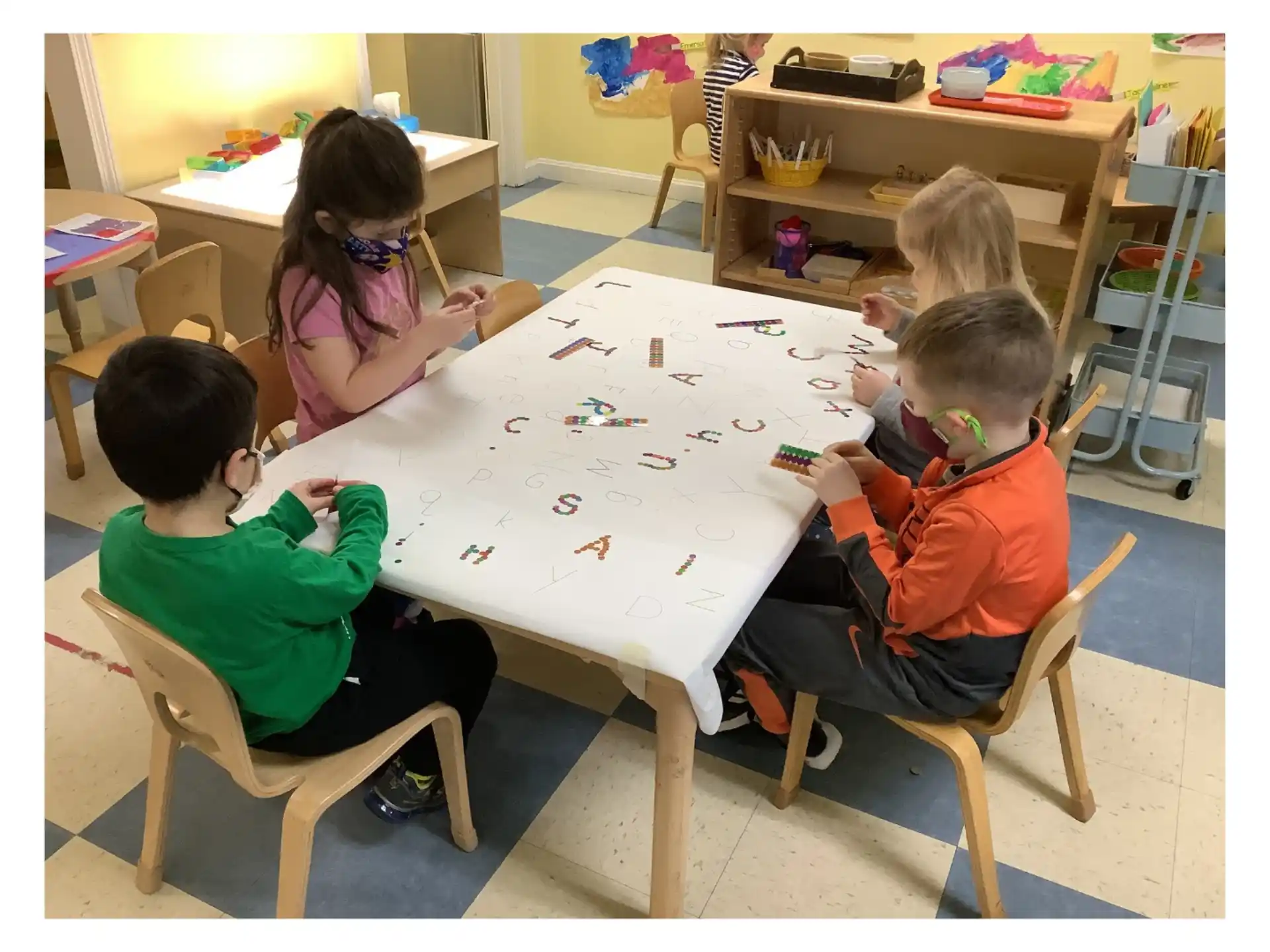 a group of children sitting around a table