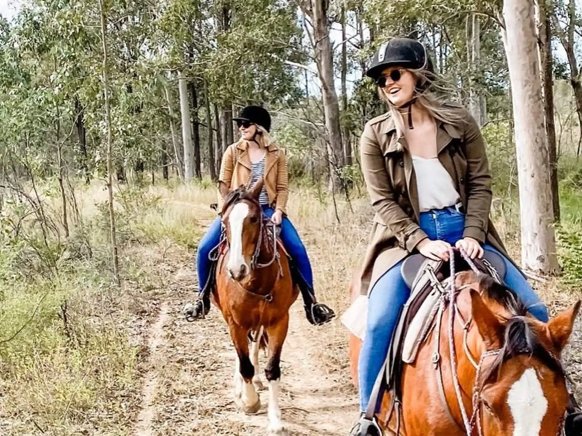 two women riding horses