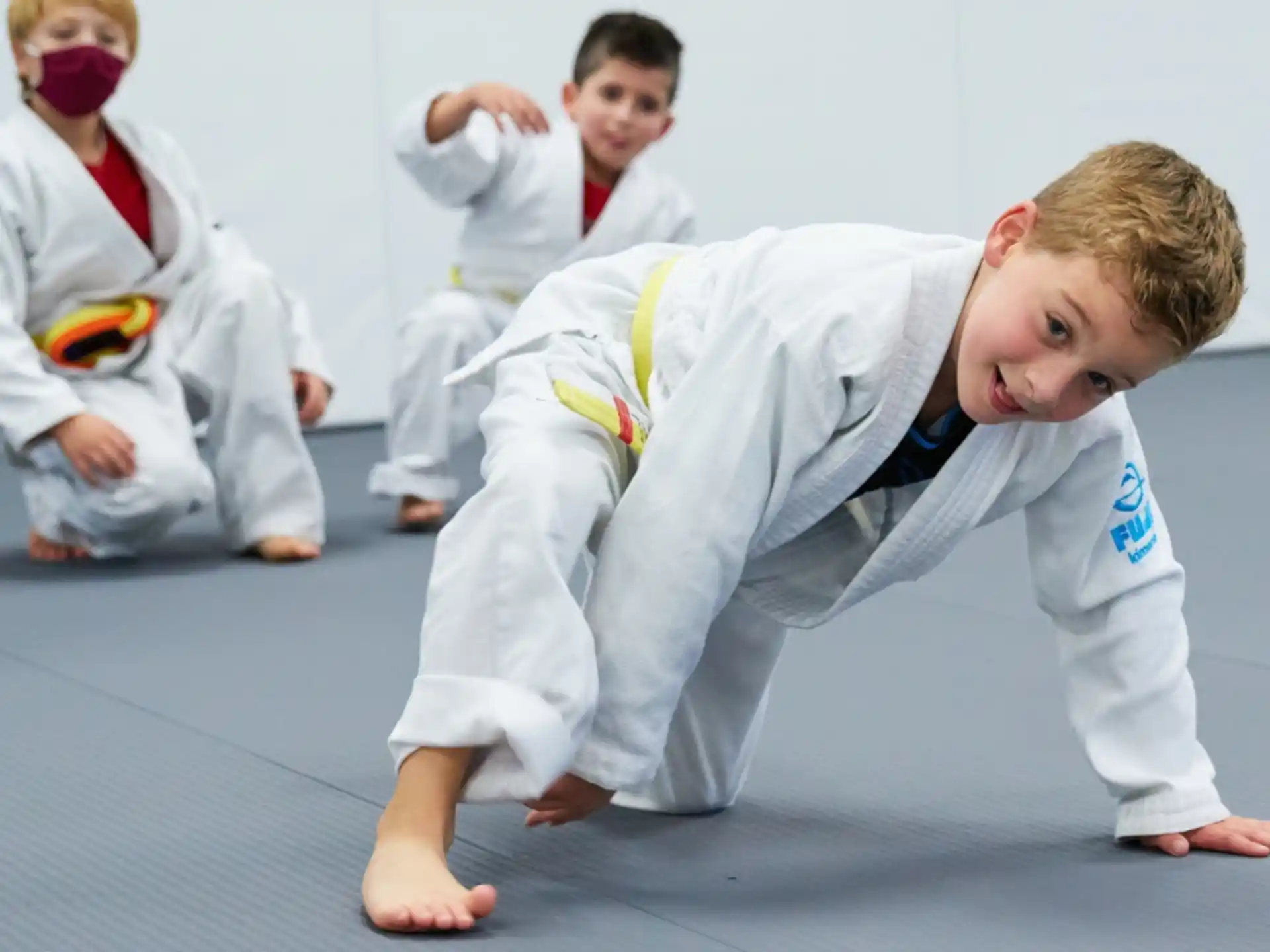 a group of children in karate uniforms