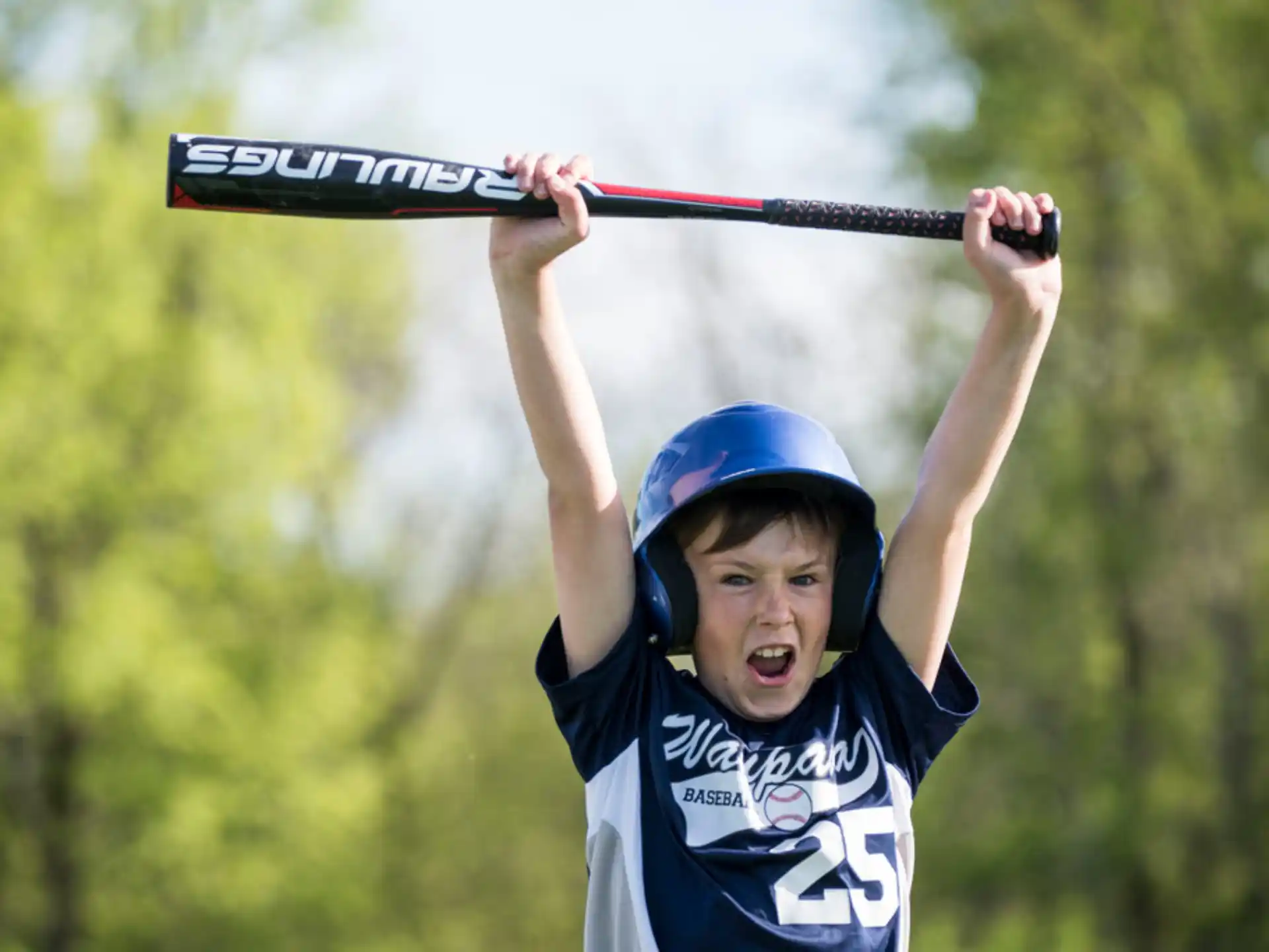 a kid holding a baseball bat