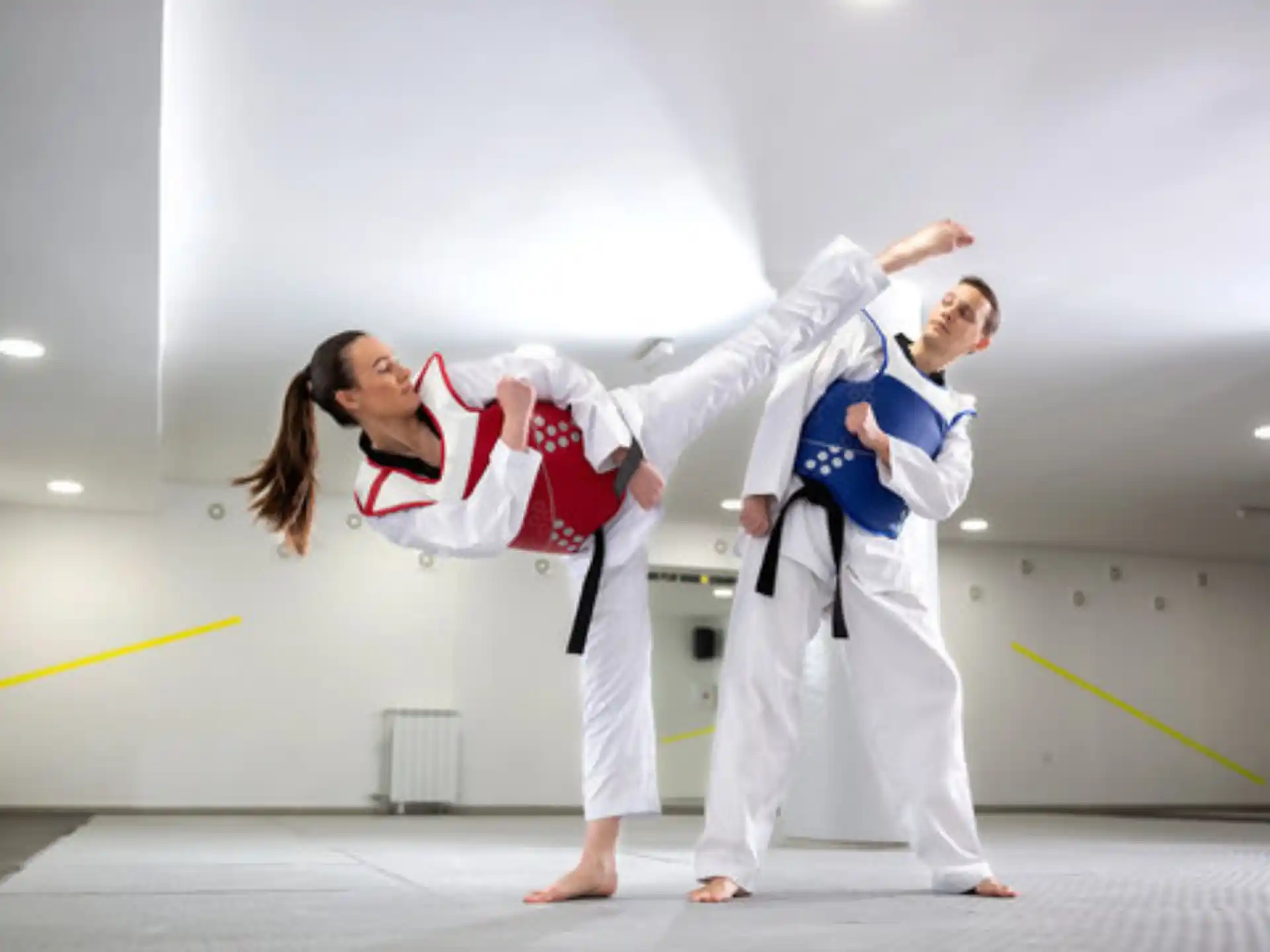 a man and woman in karate uniforms