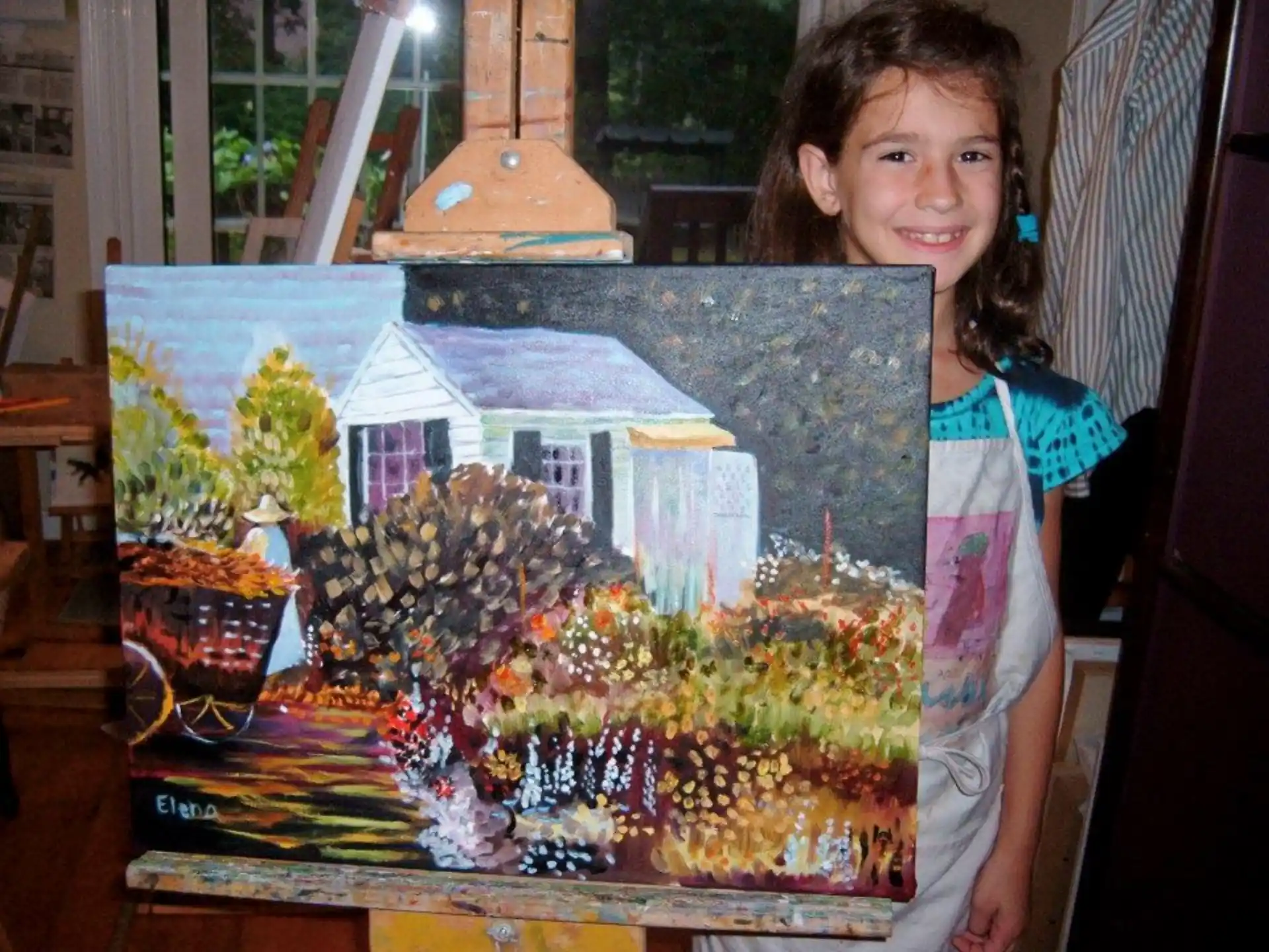 a girl standing next to a display of a house