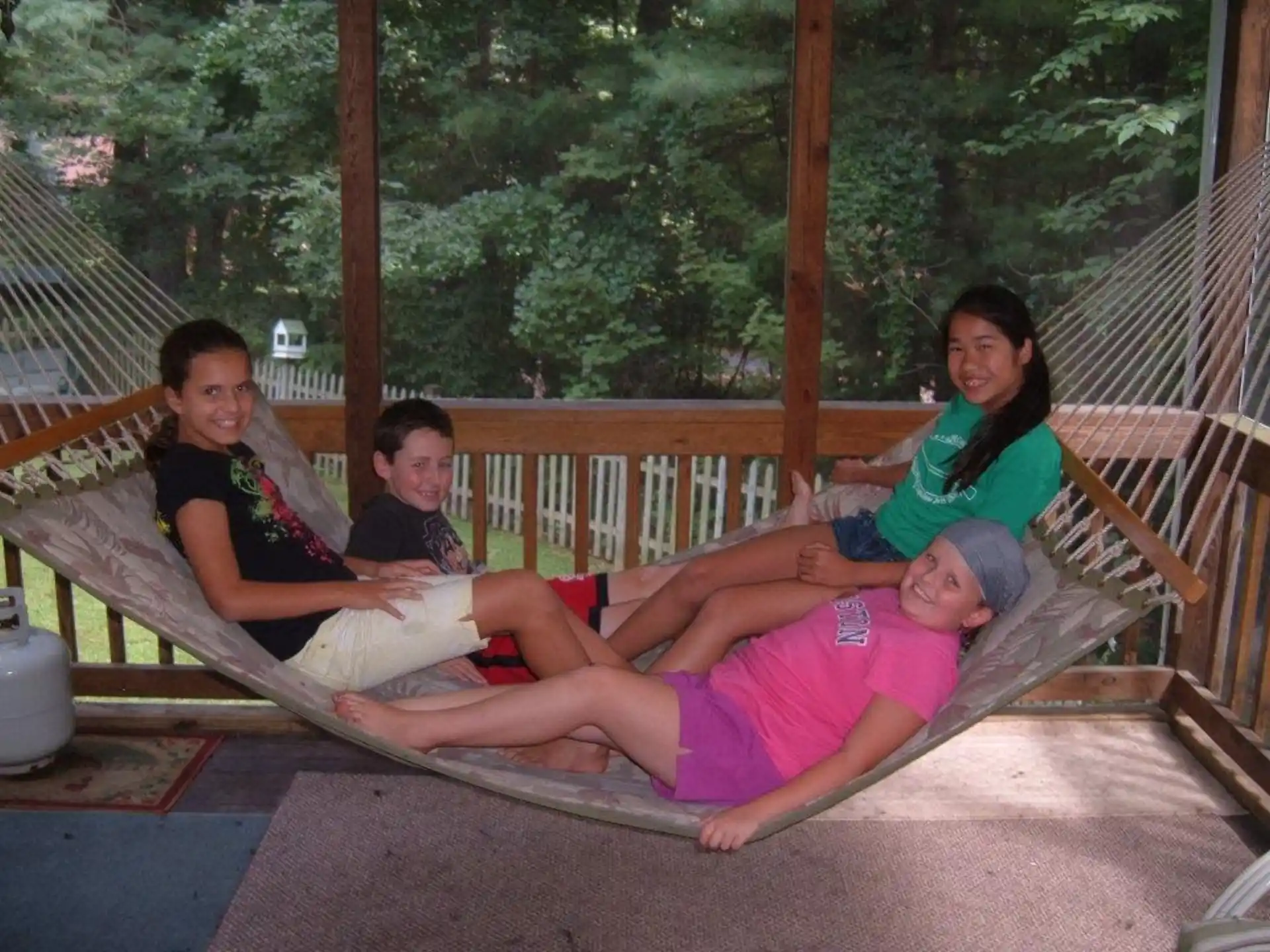 a group of people sitting on a hammock