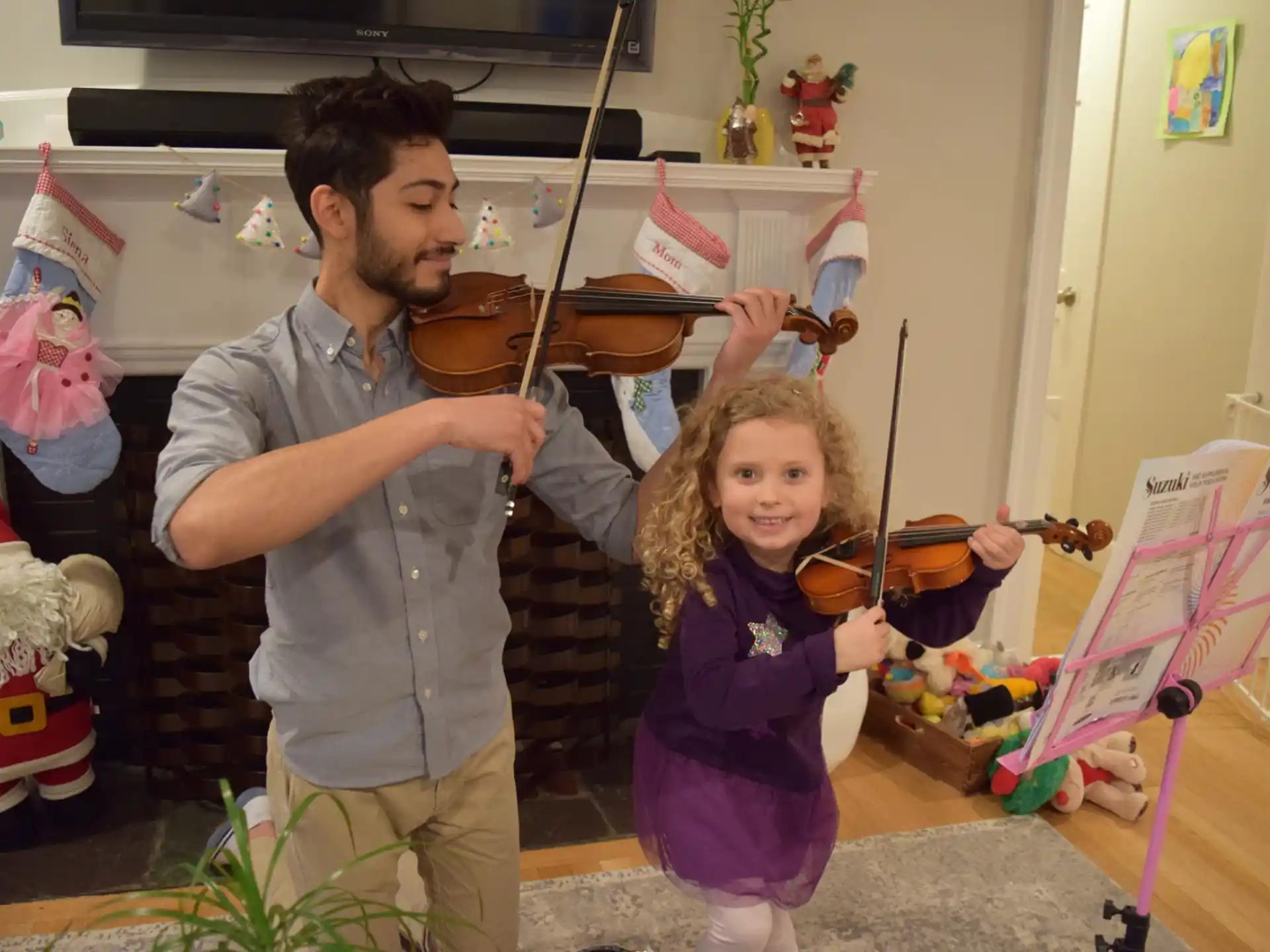 a person and a girl holding a toy sword and a bowl of food
