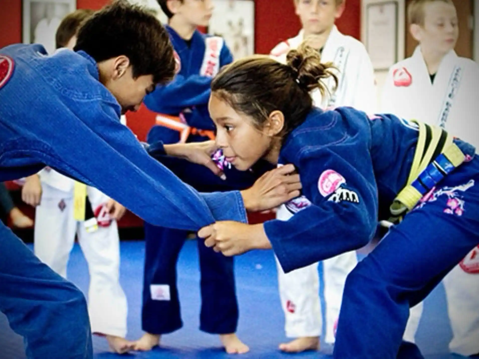 a group of children in blue karate uniforms