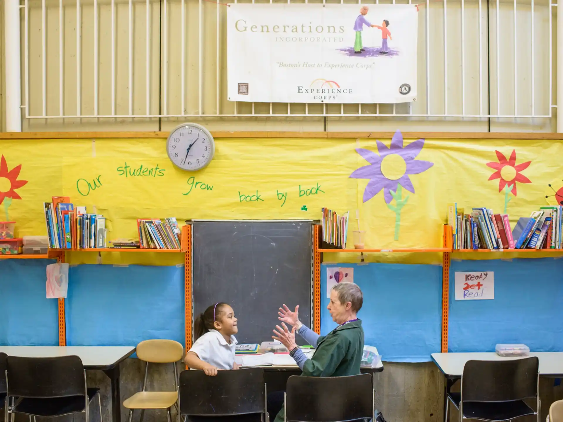 a group of people sitting at a table in a classroom