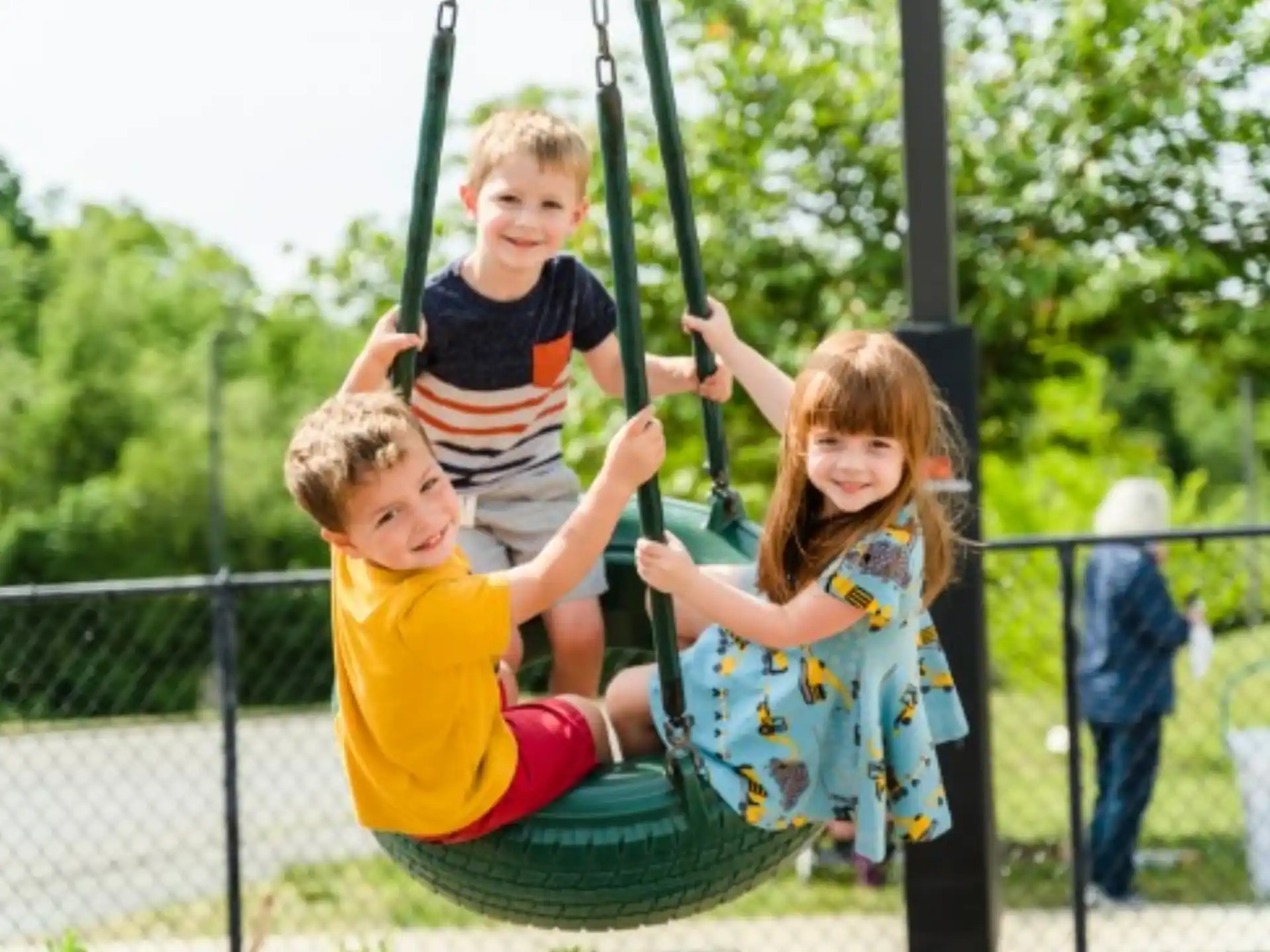 a group of children on a swing