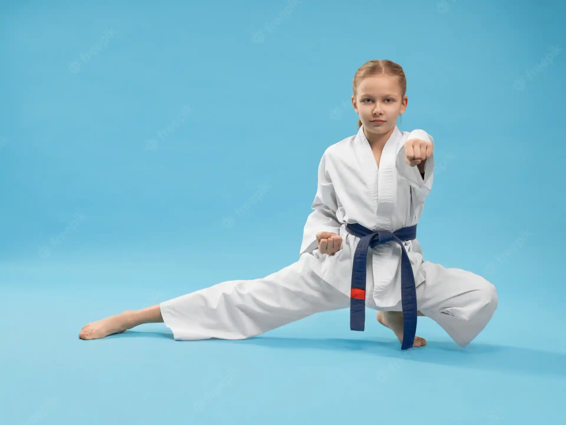 a young girl in a karate uniform