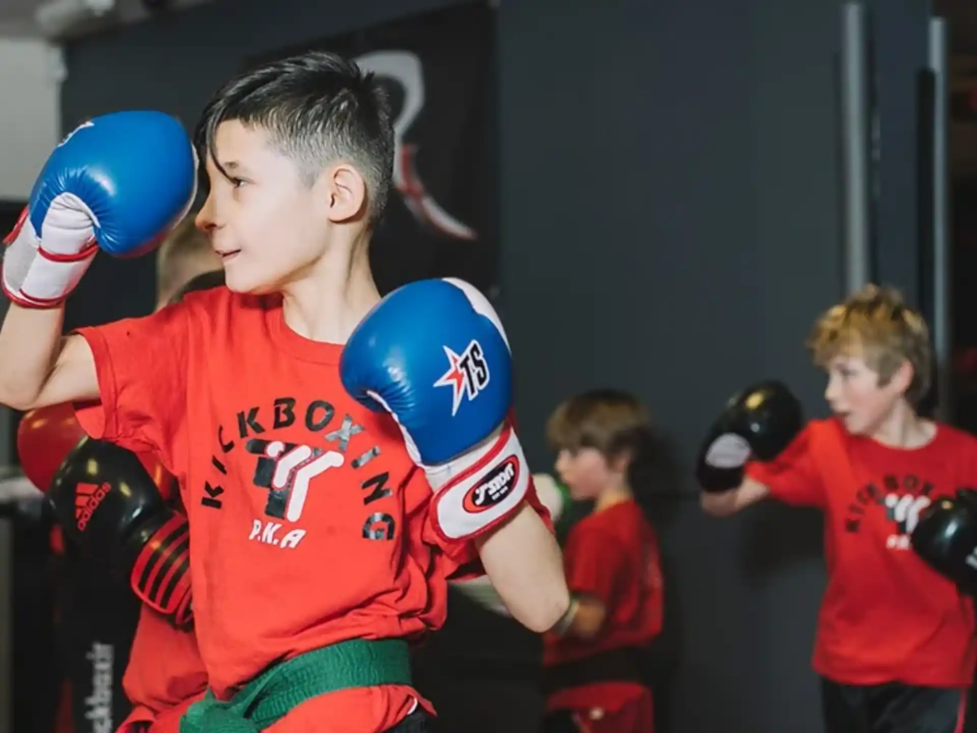 a group of kids wearing boxing gloves