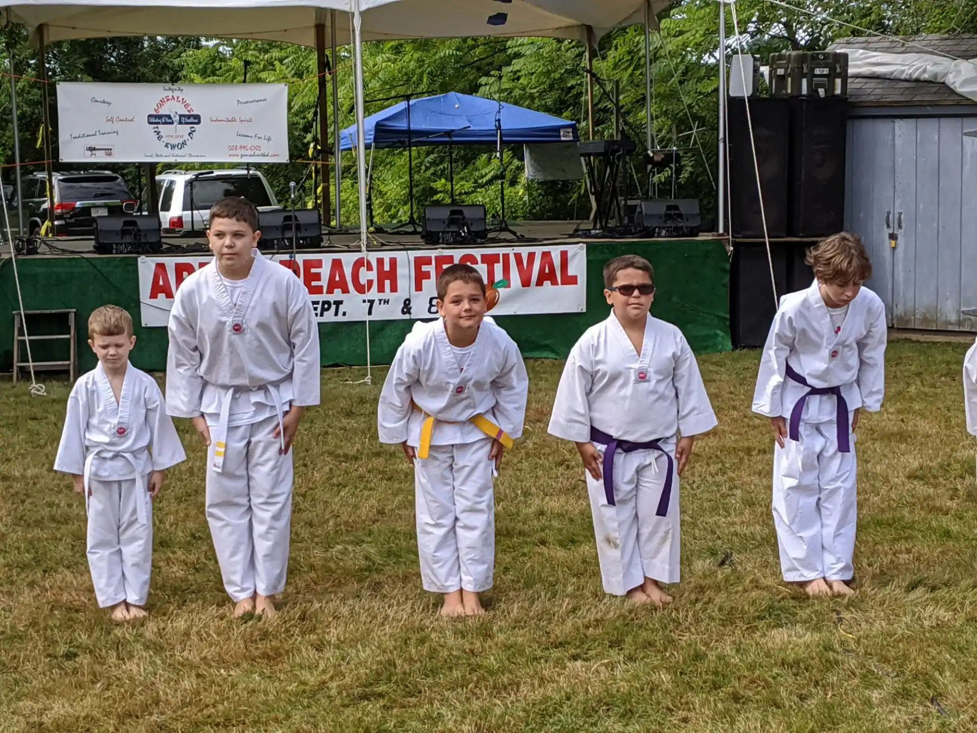 a group of people in white karate uniforms