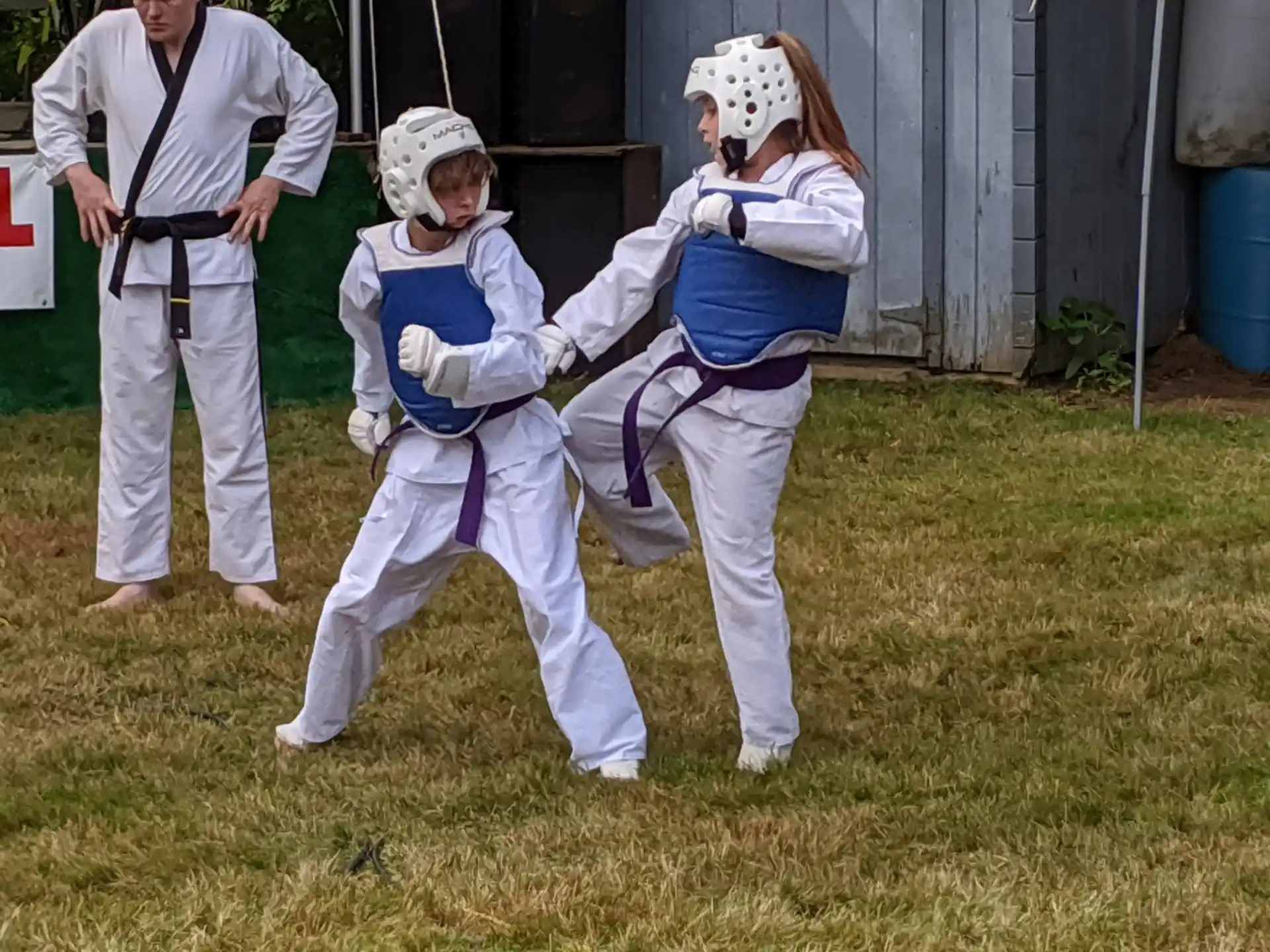 a group of people in white karate uniforms