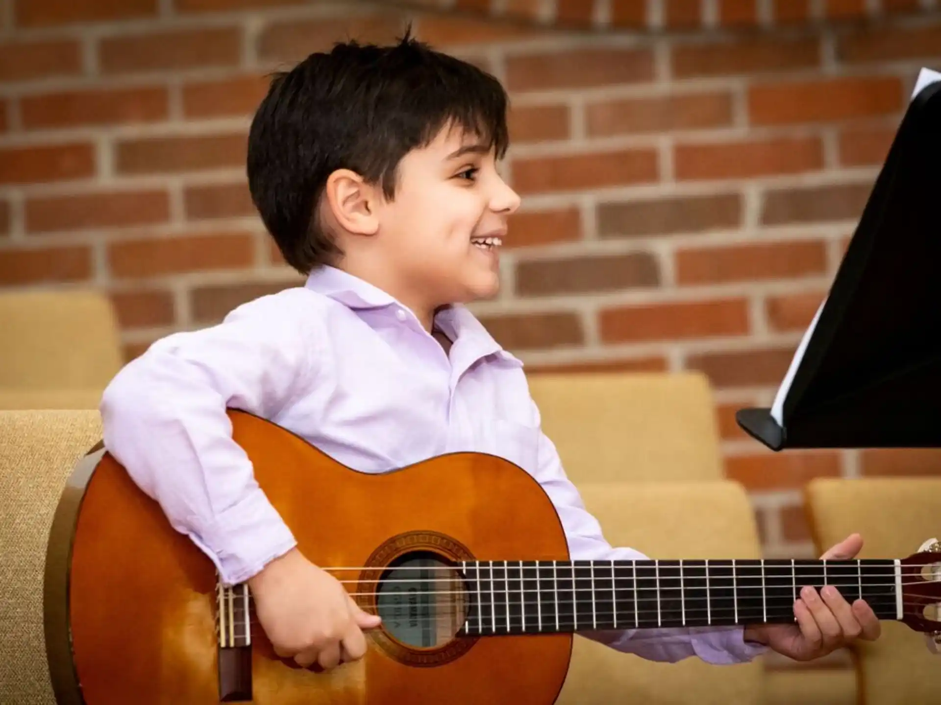 a boy playing a guitar