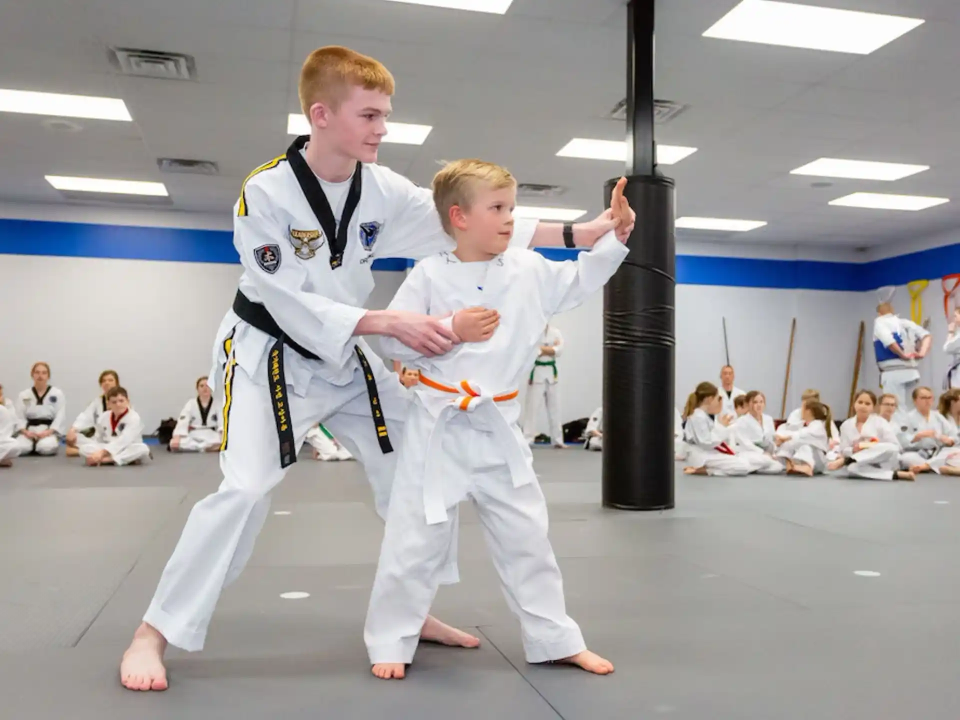 a couple of boys in karate uniforms