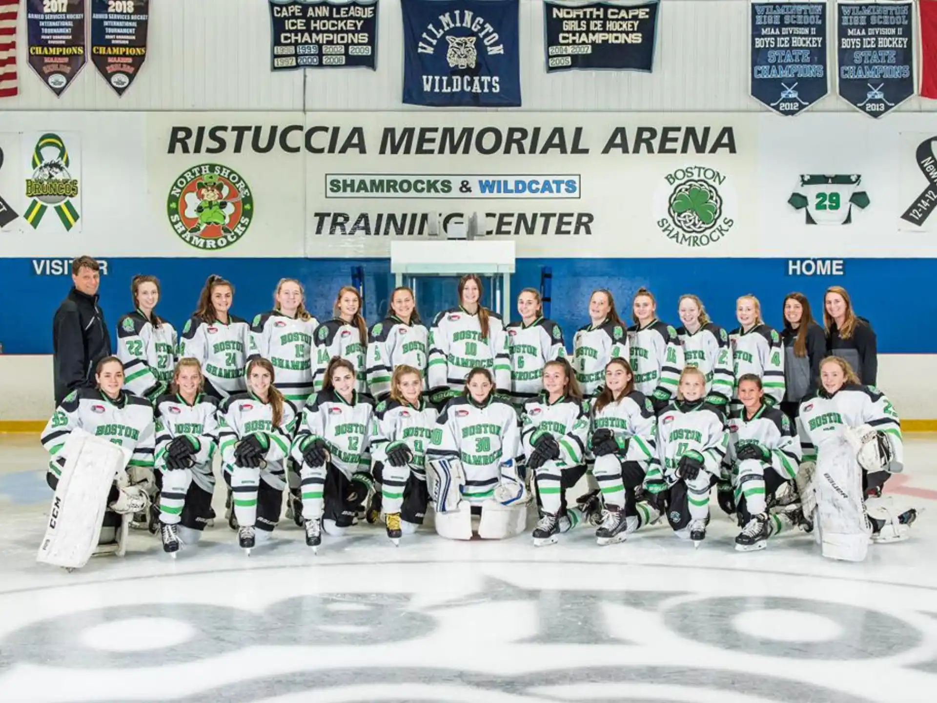a group of people posing for a photo on ice