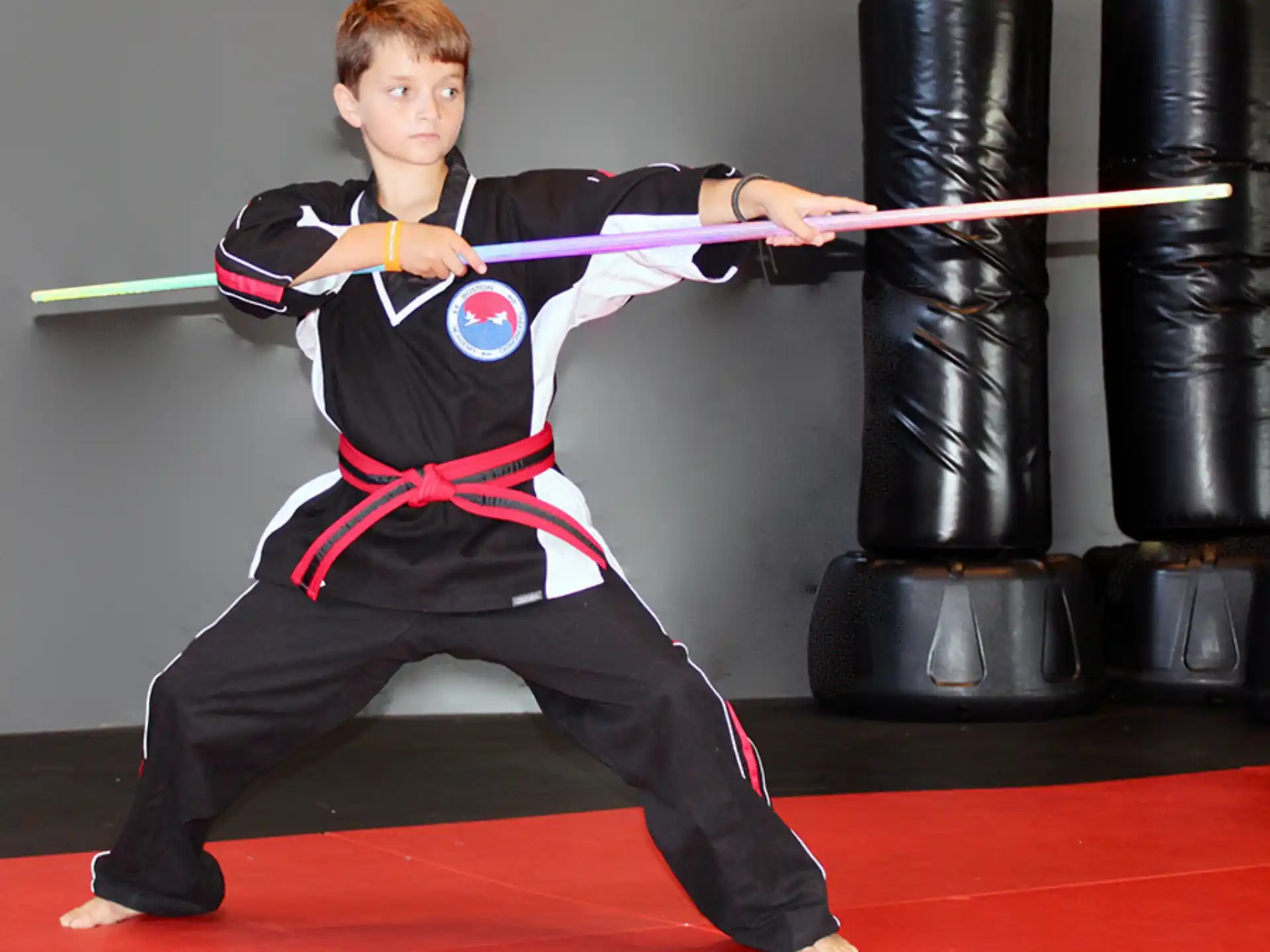 a boy in a martial arts uniform