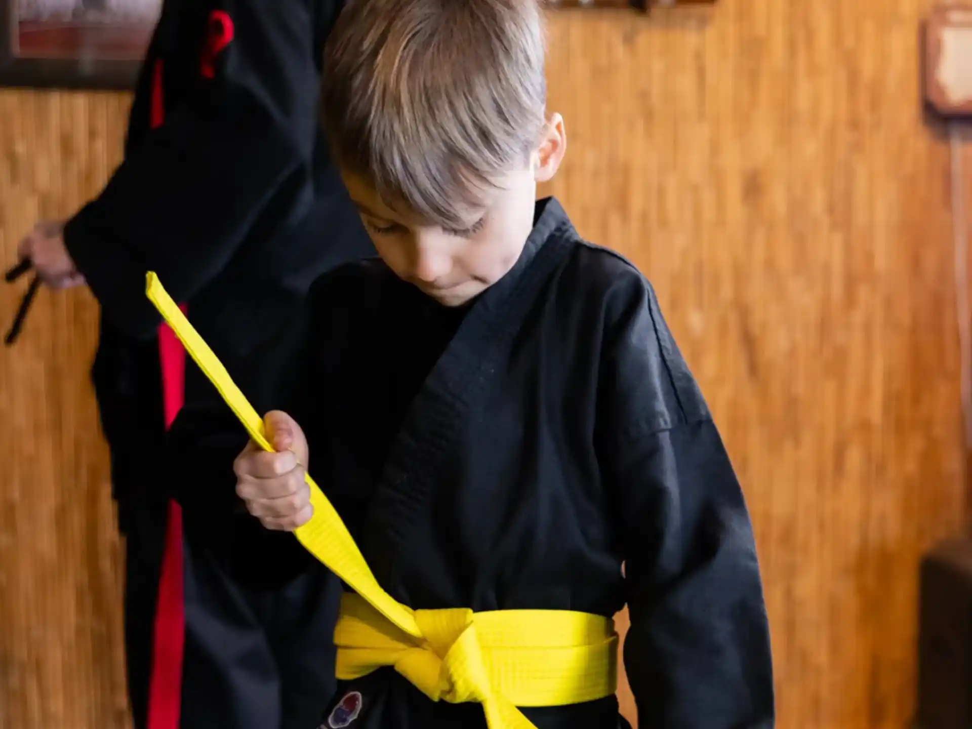 a boy holding a yellow umbrella