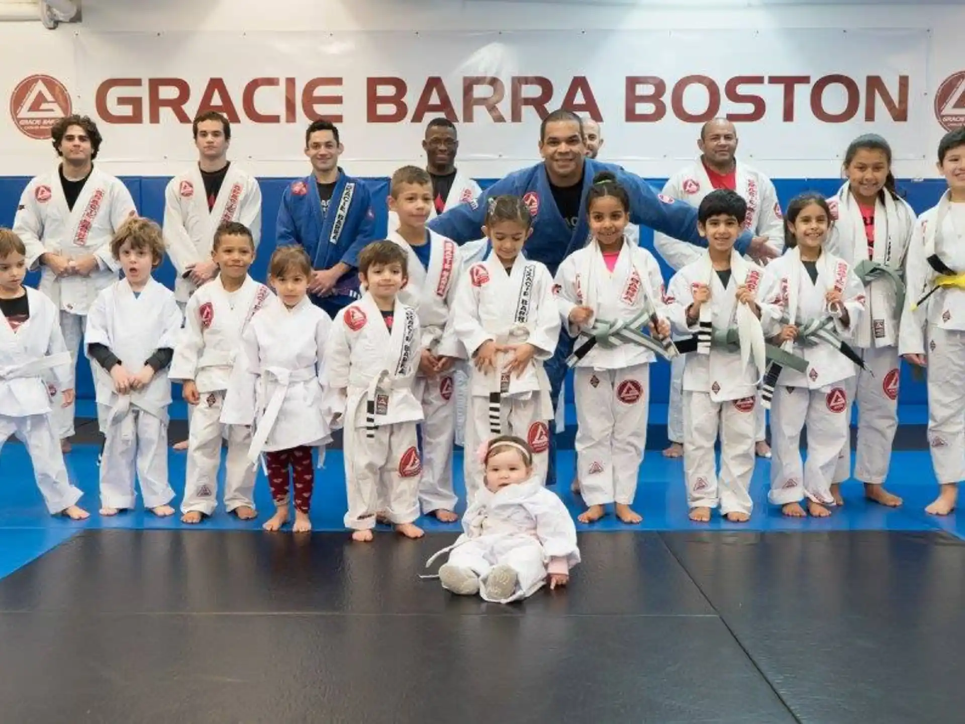 a group of people in white karate uniforms posing for a photo