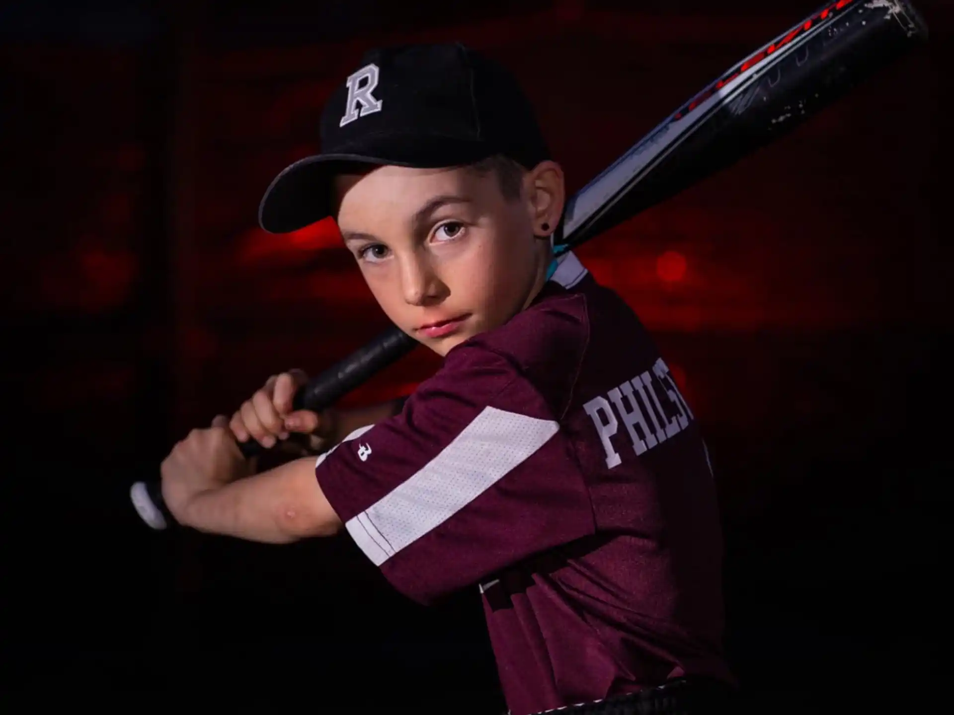 a boy holding a baseball bat