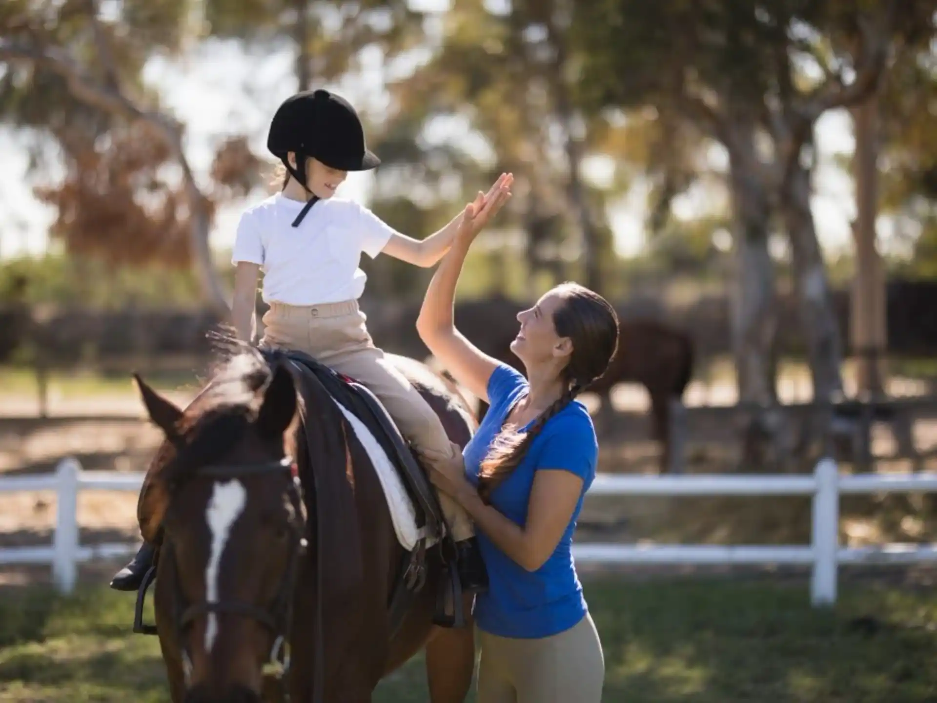 a woman riding a horse with a child on the back