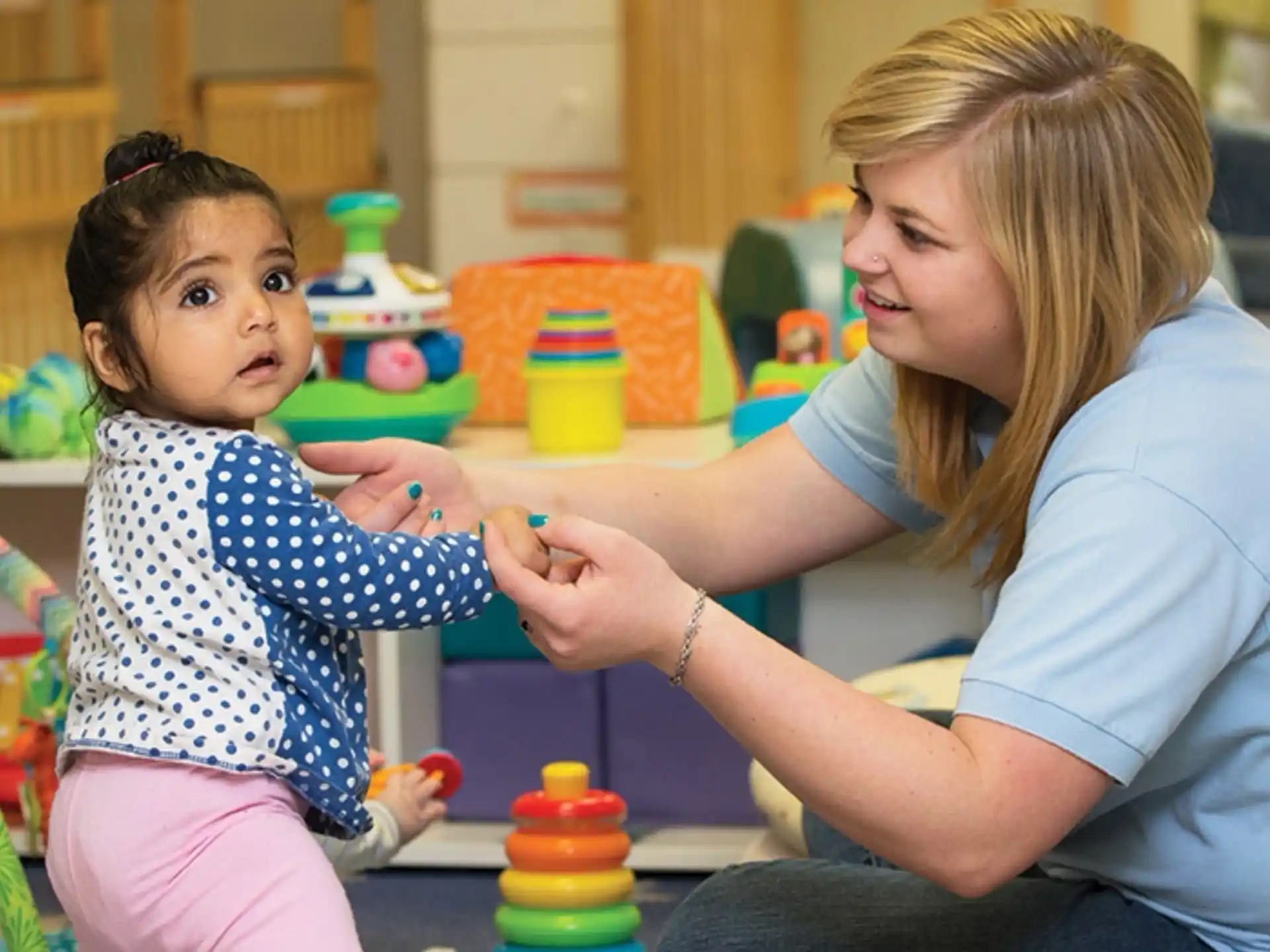 a person and a child playing with toys