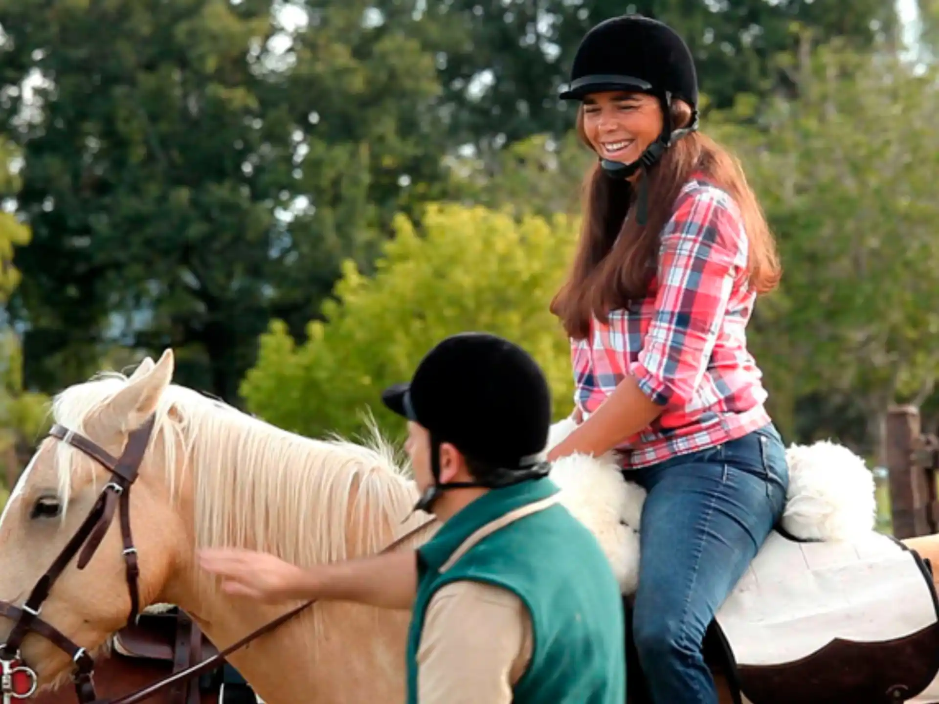 a person riding a horse with a child on the back