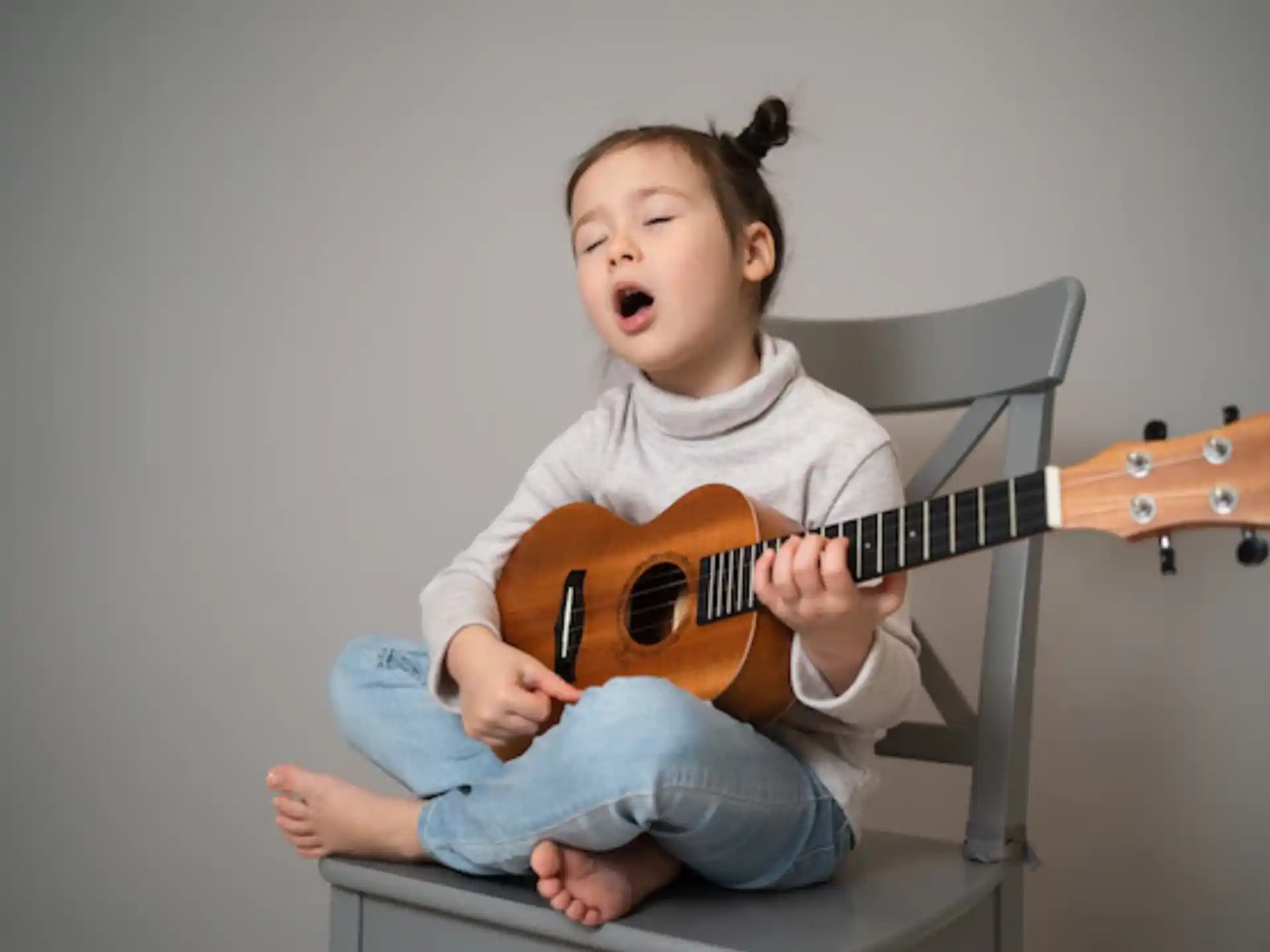 a baby playing a guitar