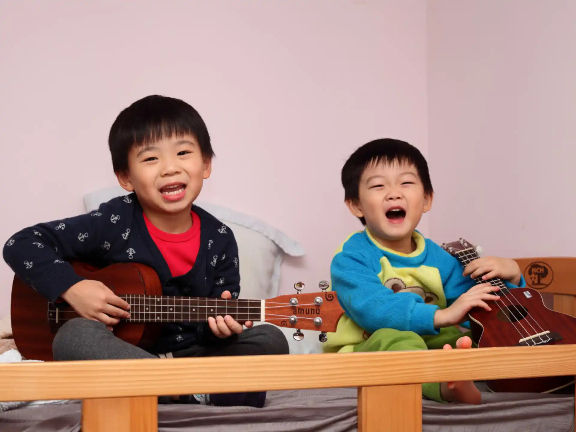 two boys holding guitars