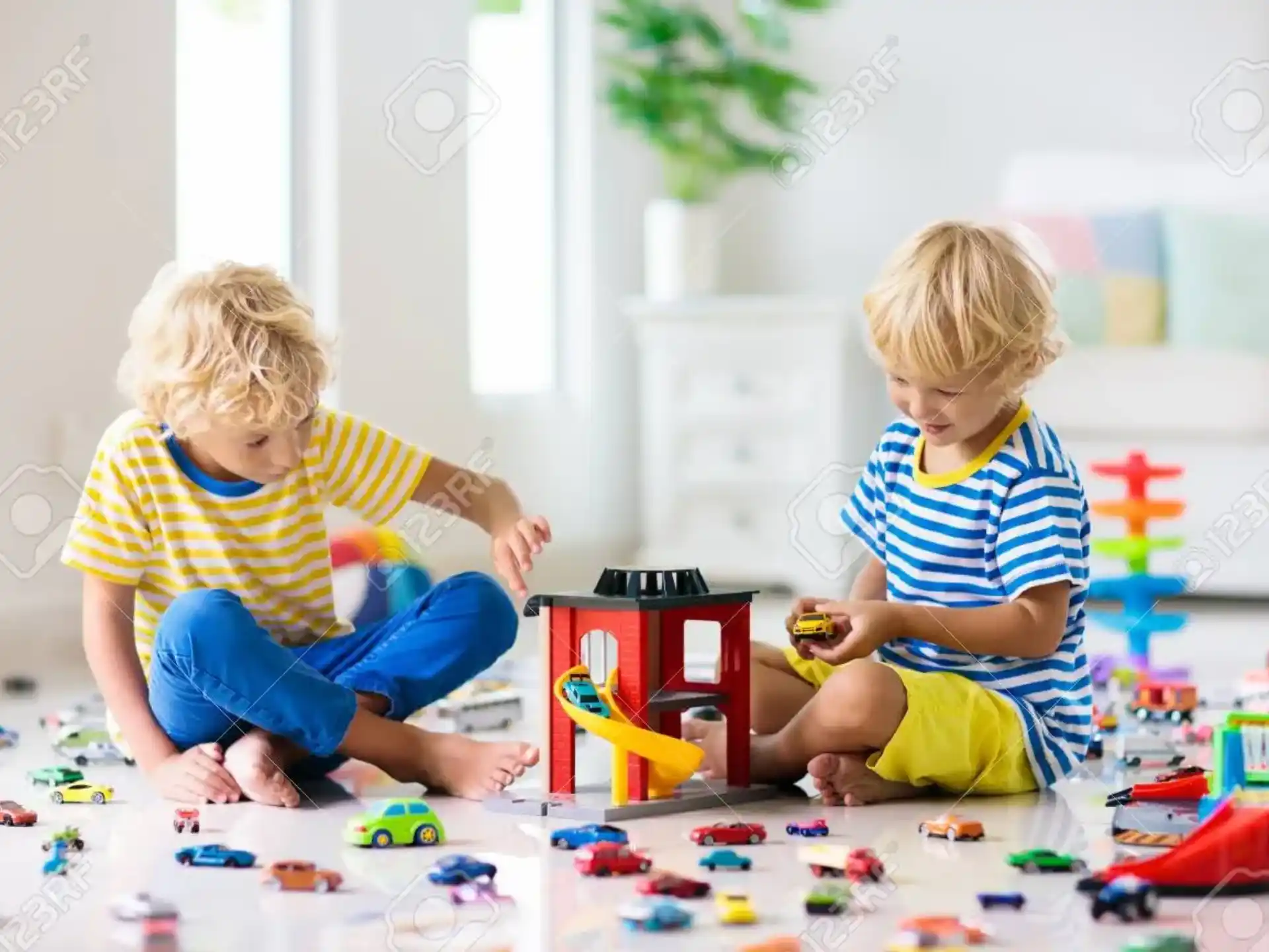 two boys playing with toys