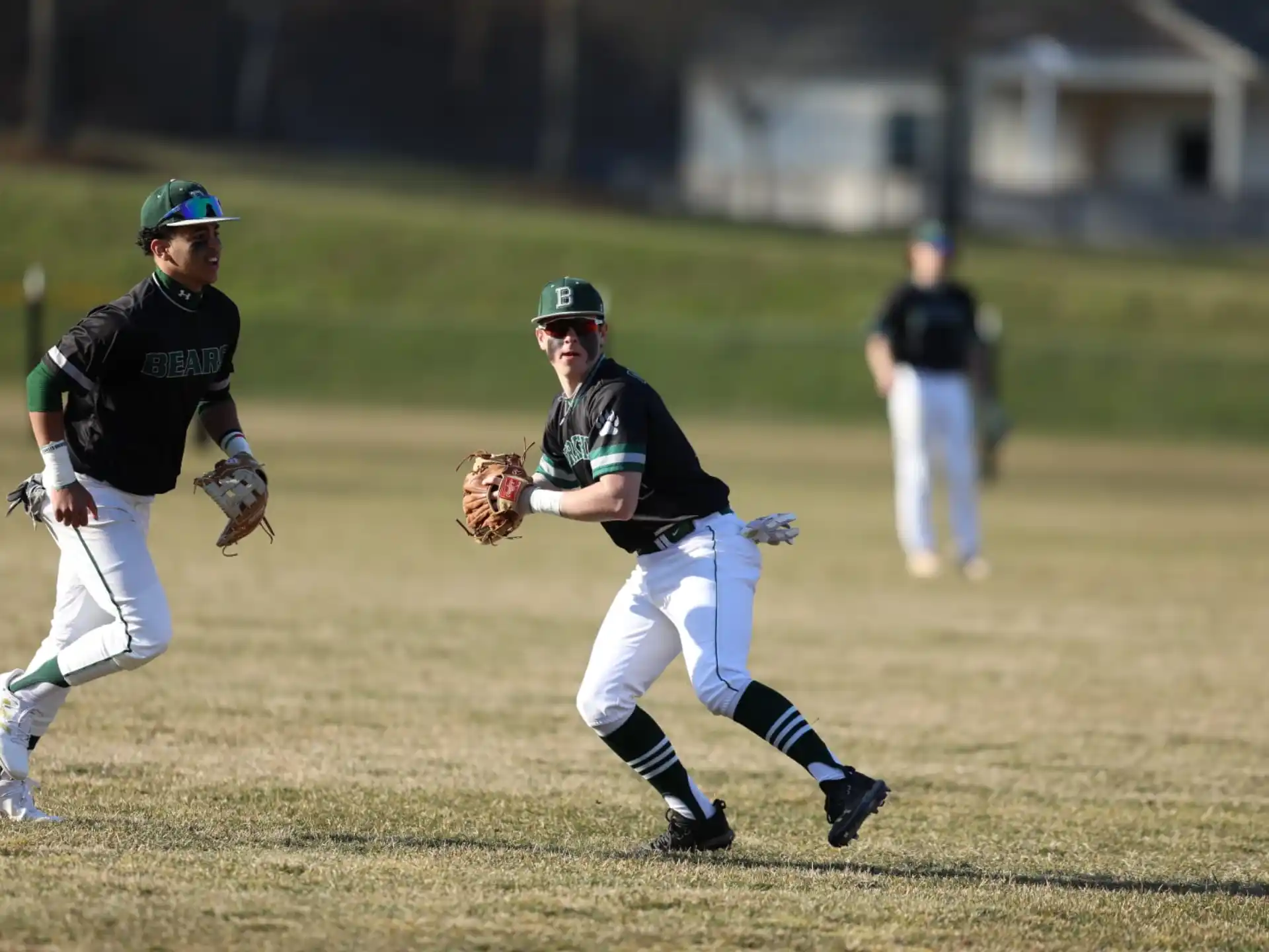 a couple of young boys playing baseball