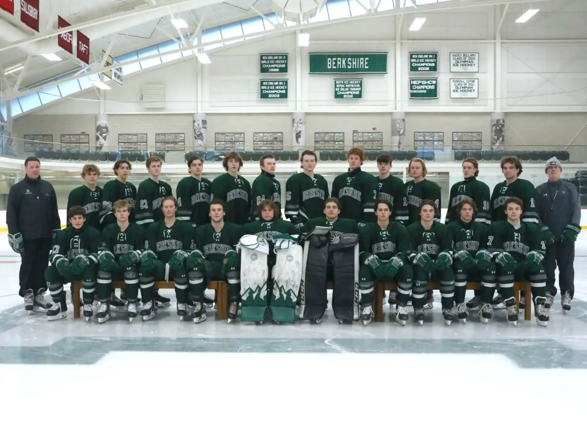 a group of people posing for a photo on an ice rink