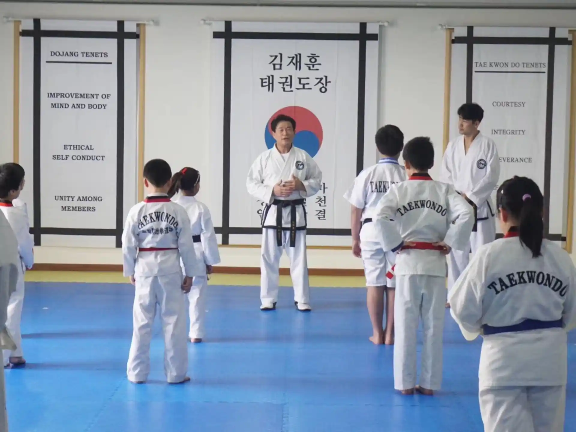 a group of people in white karate uniforms
