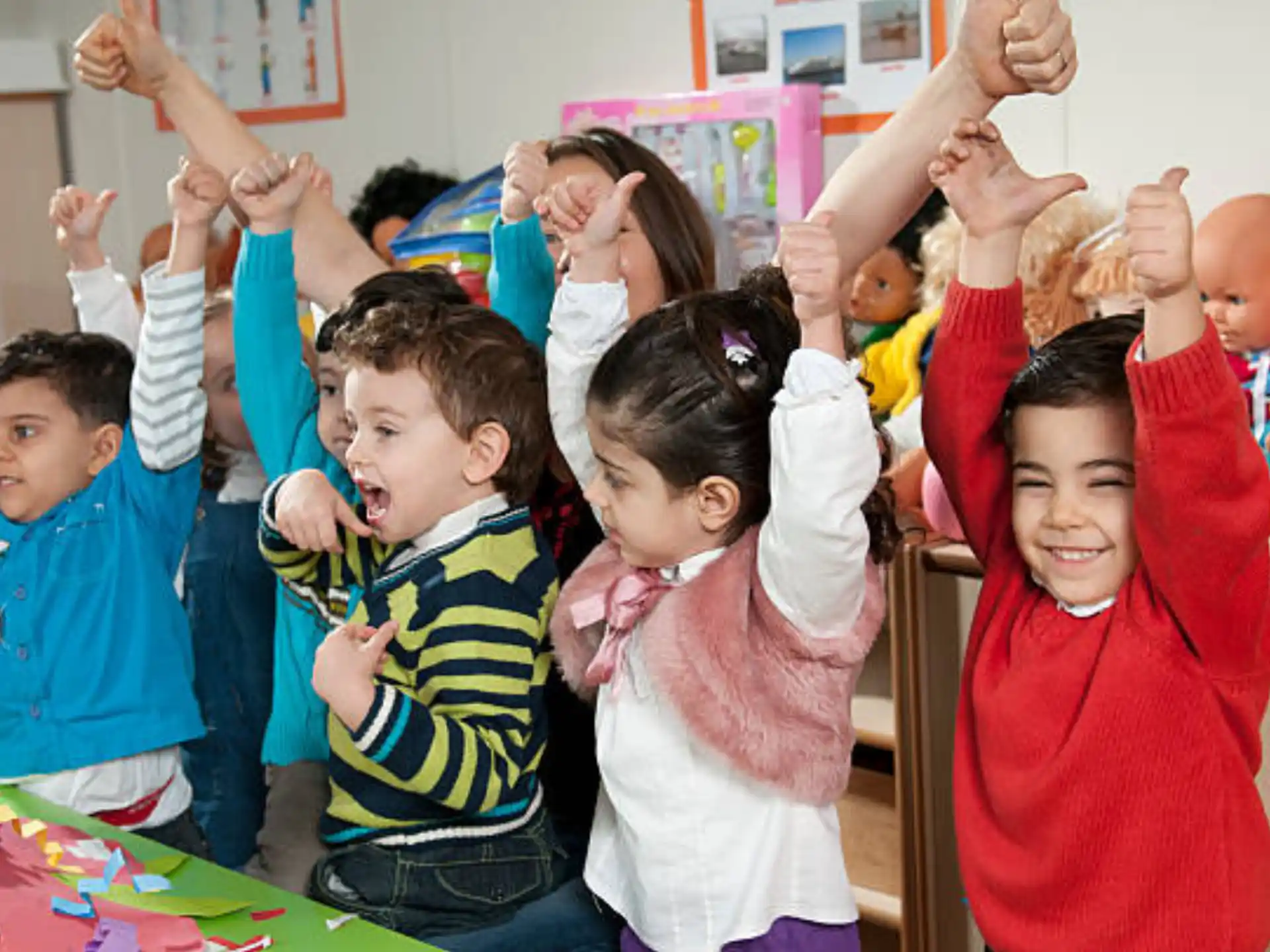 a group of children raising their hands