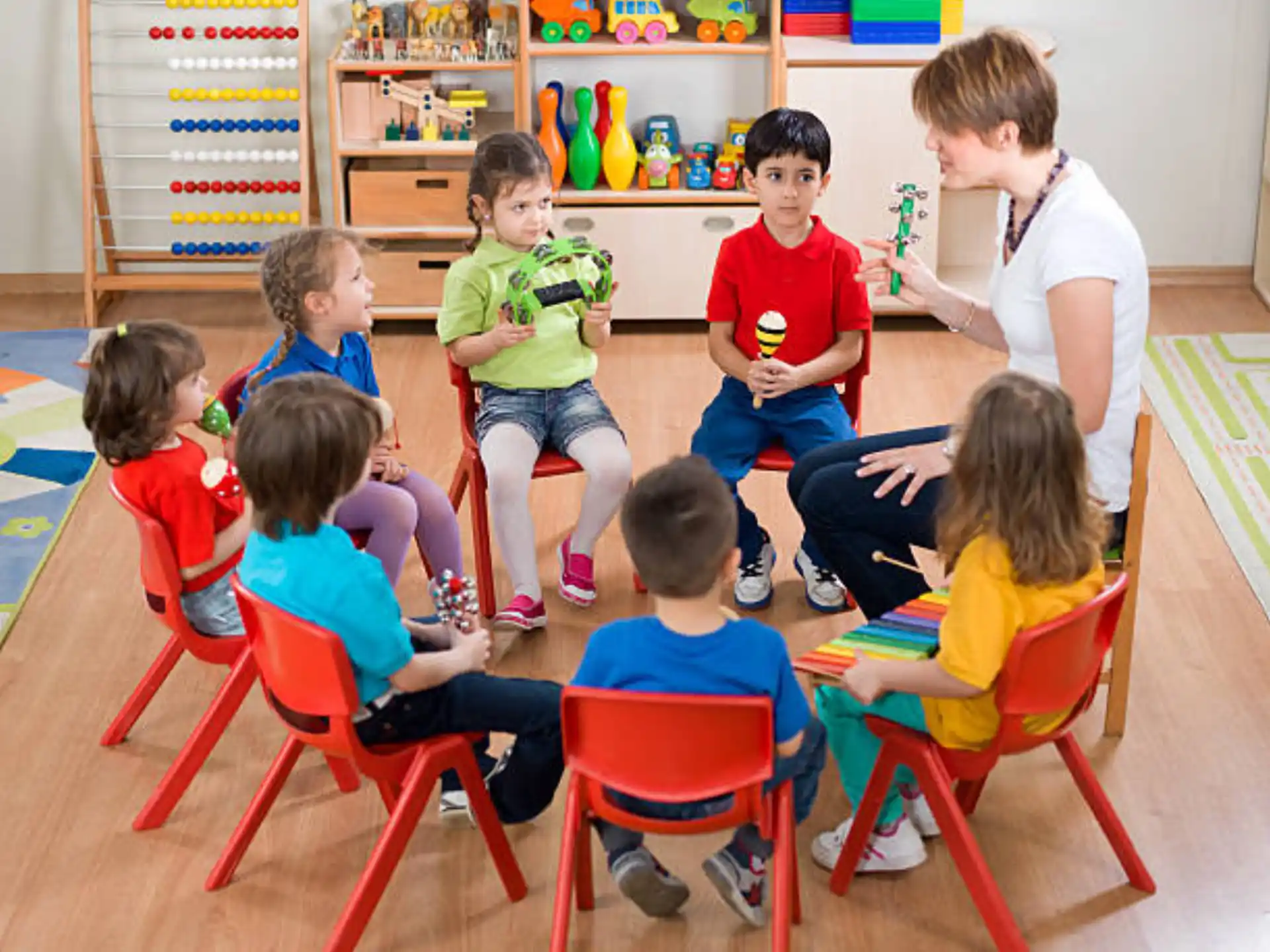 a group of children sitting in chairs