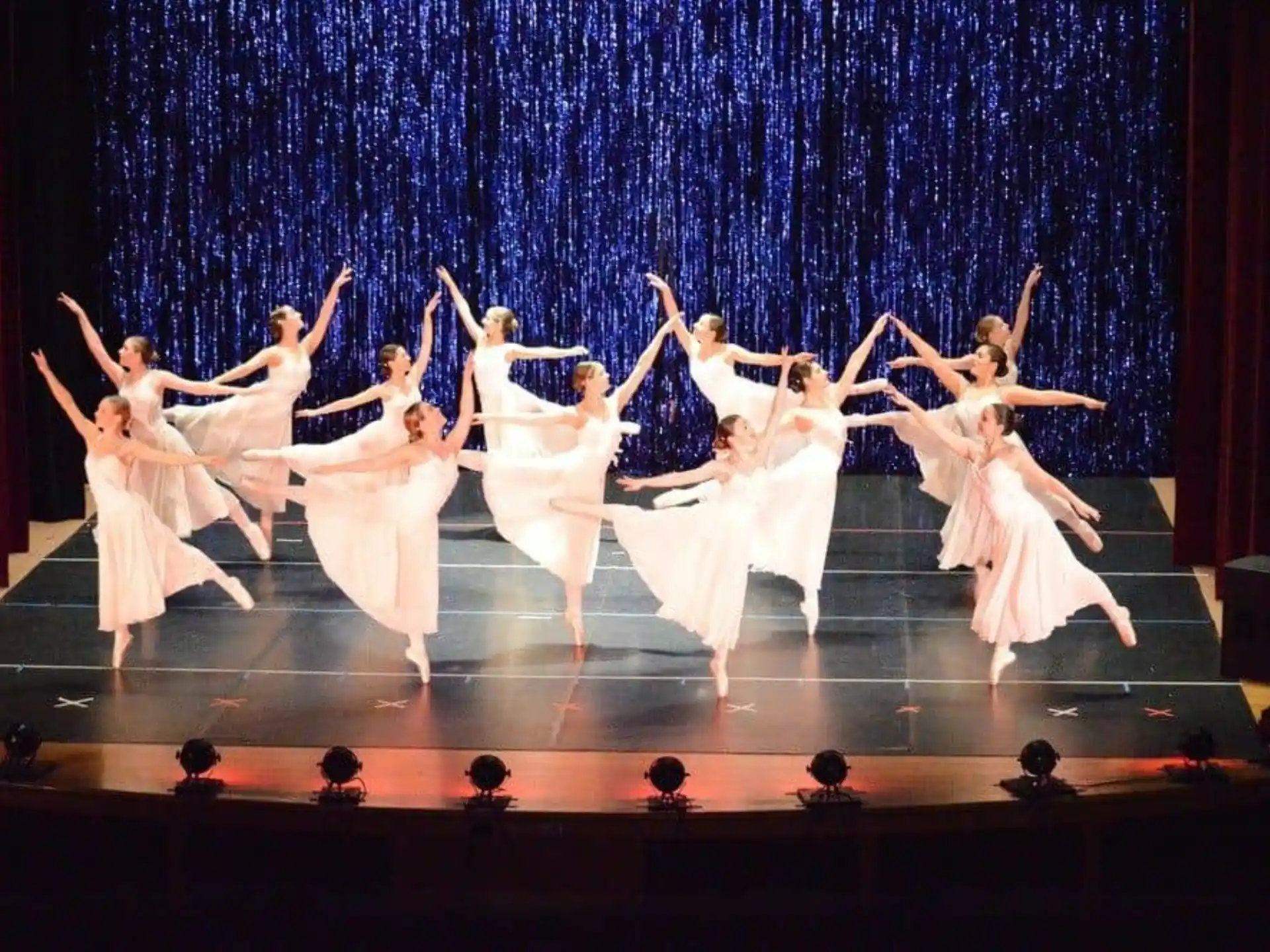 a group of people dancing on a stage