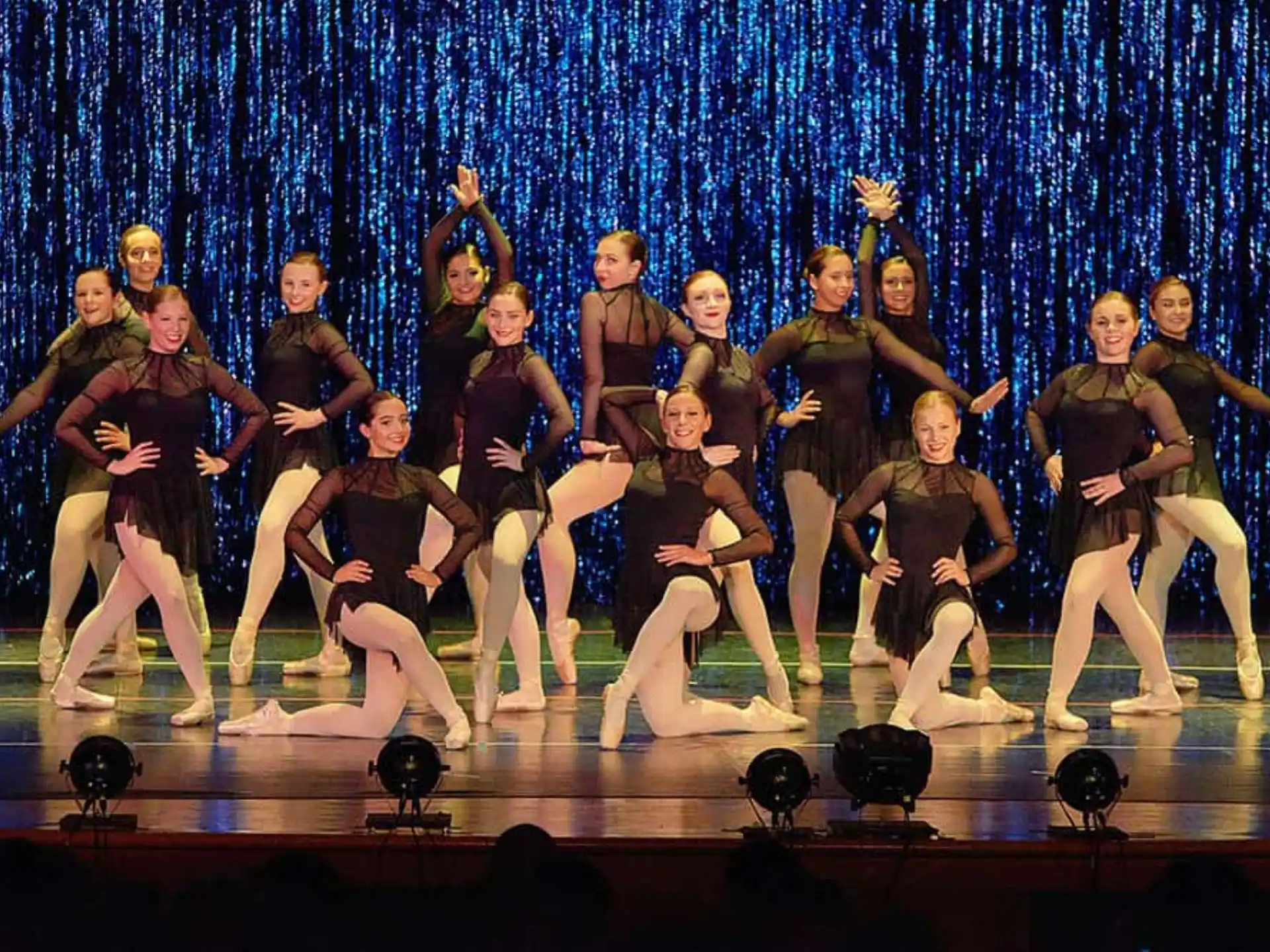 a group of people dancing on a stage