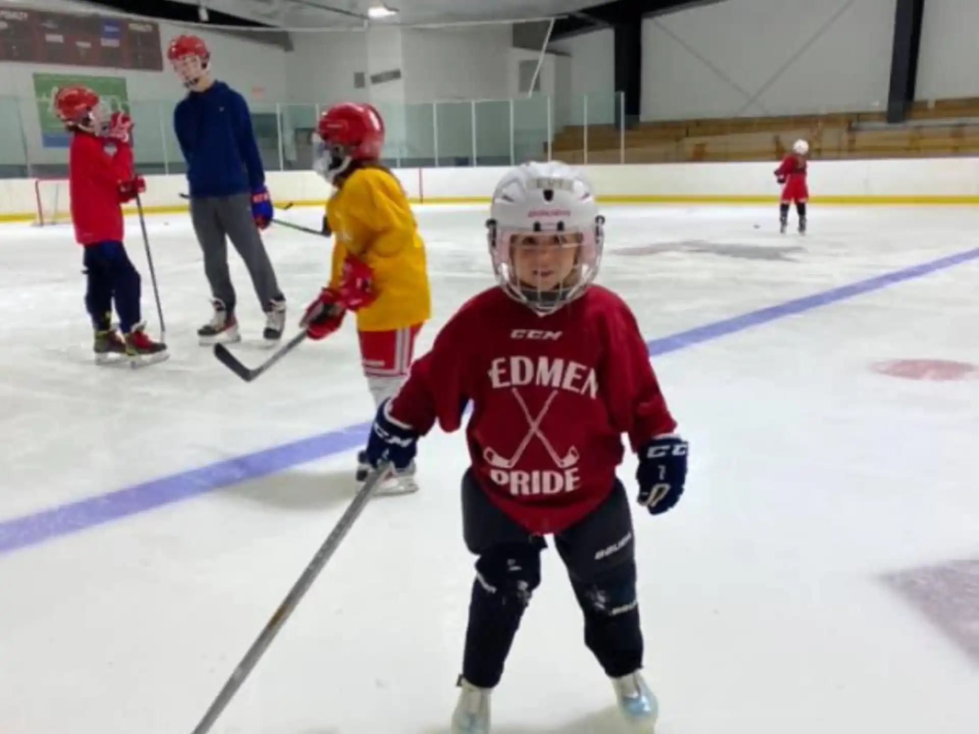 a group of kids playing hockey