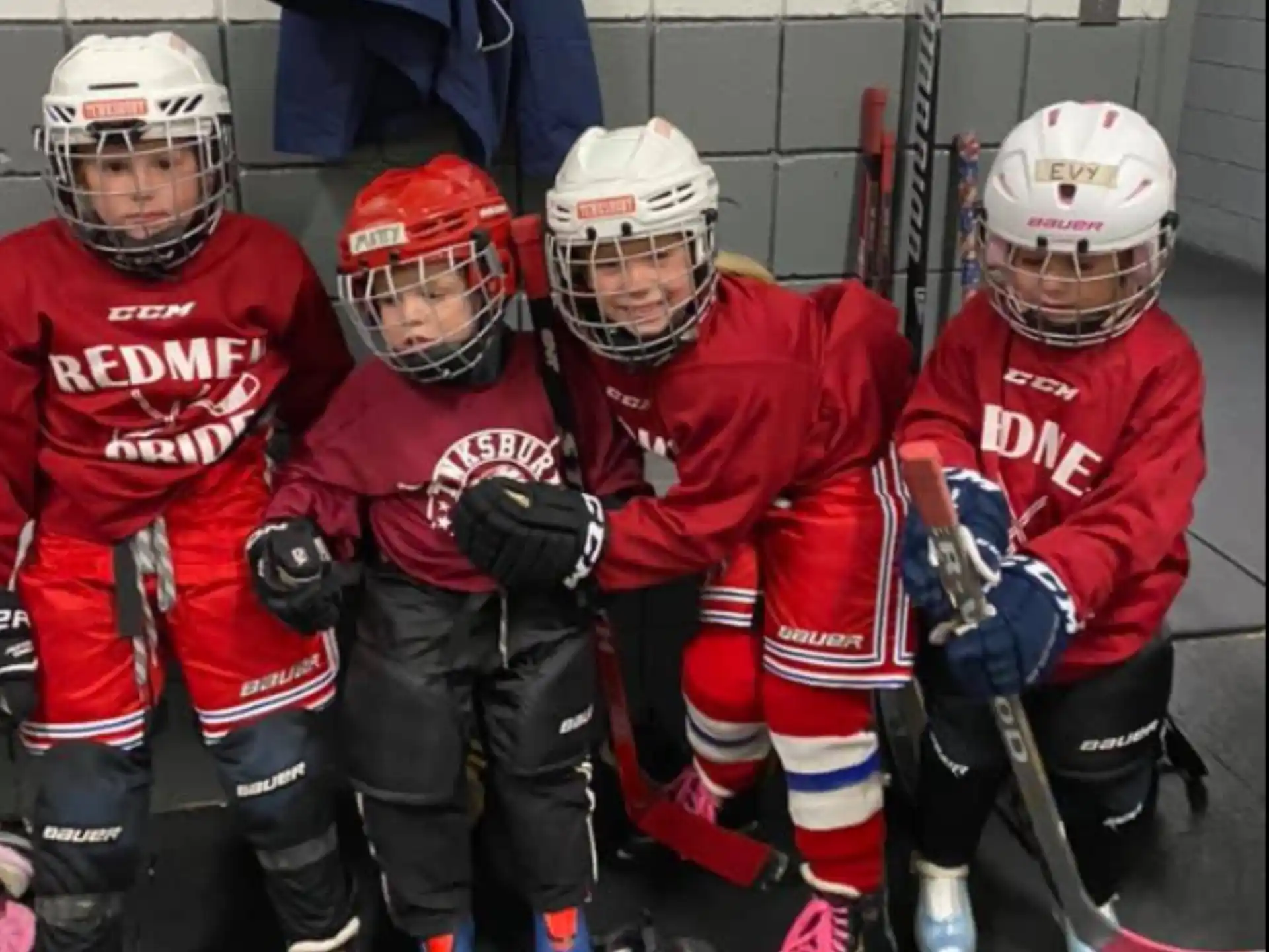 a group of kids wearing hockey gear