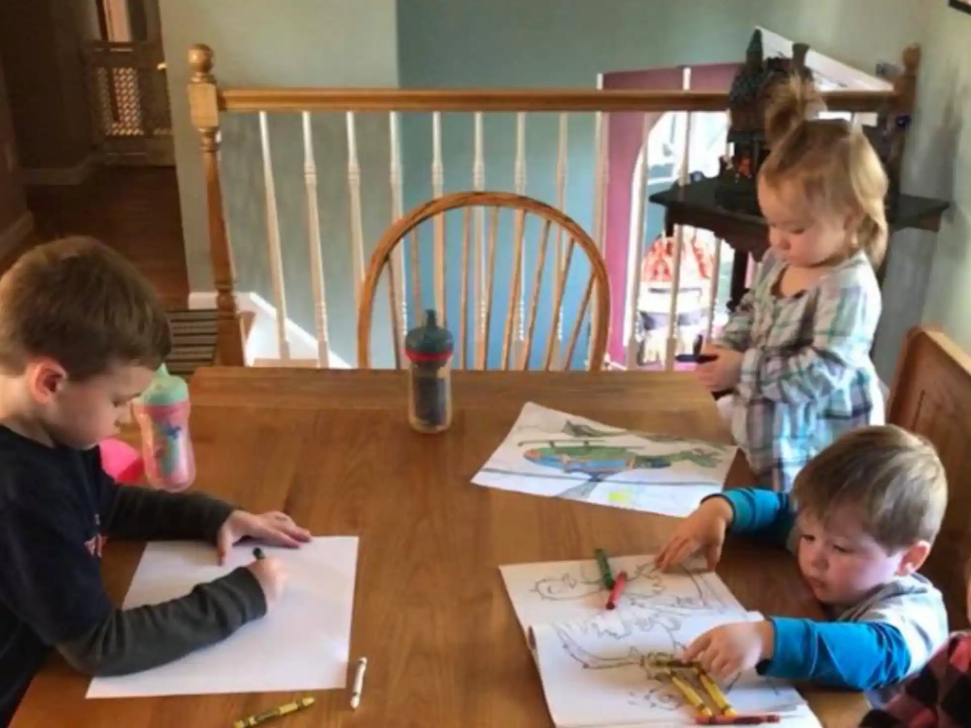 a group of children sitting at a table