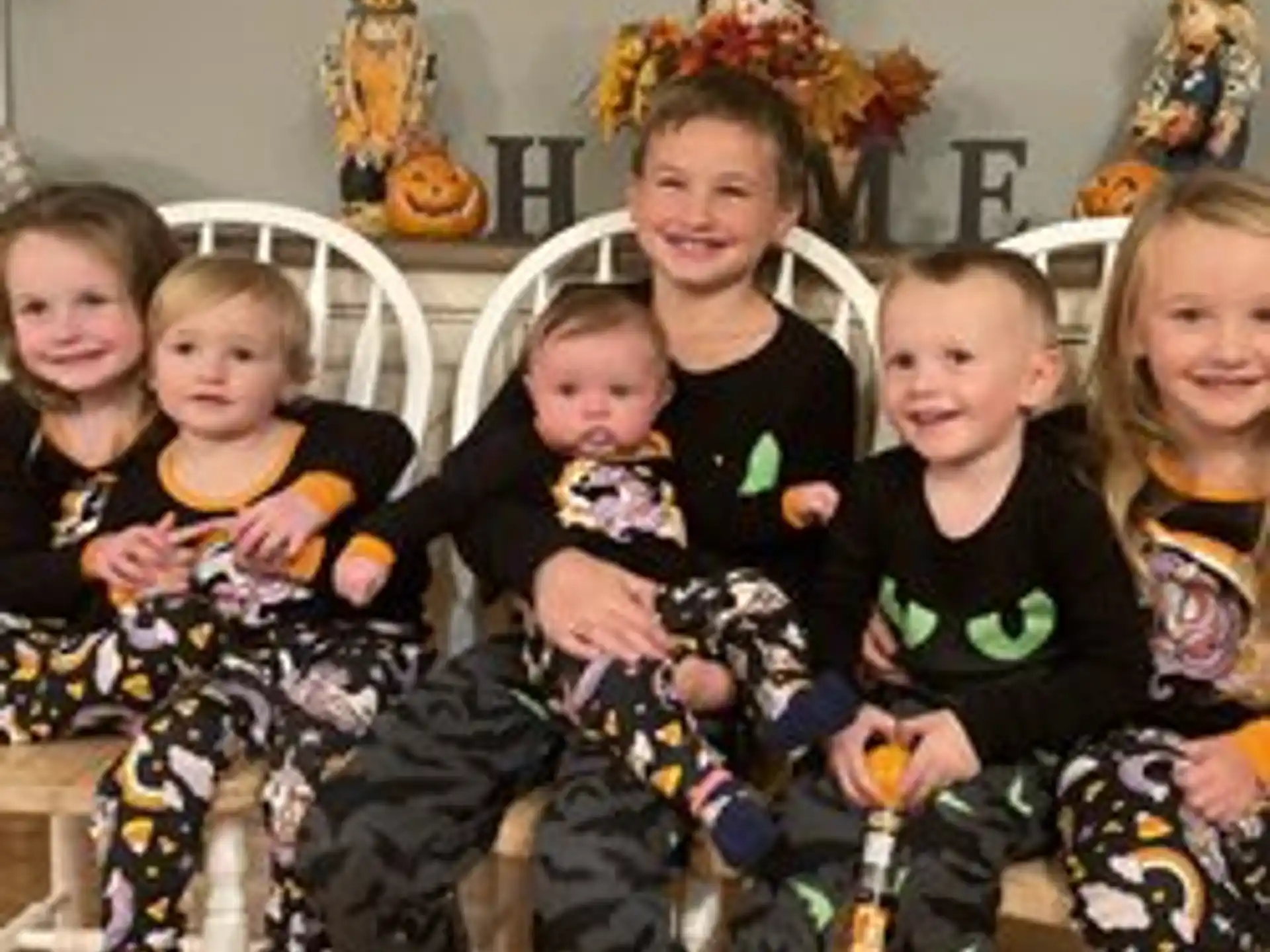 a group of children sitting on a couch