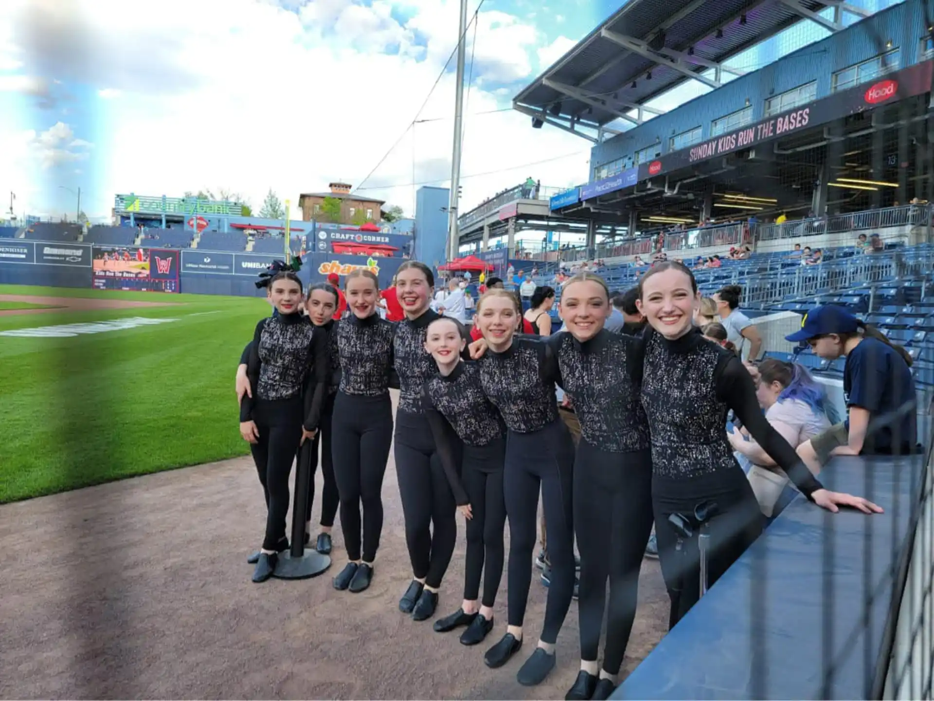 a group of people posing for a photo in a stadium