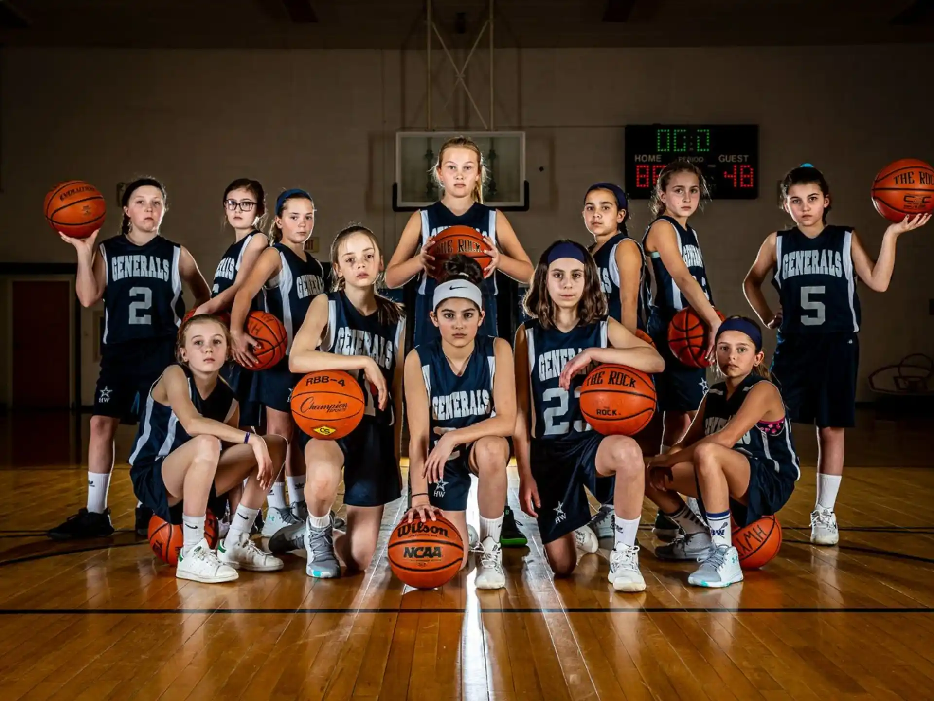 a group of kids posing for a photo with basketballs