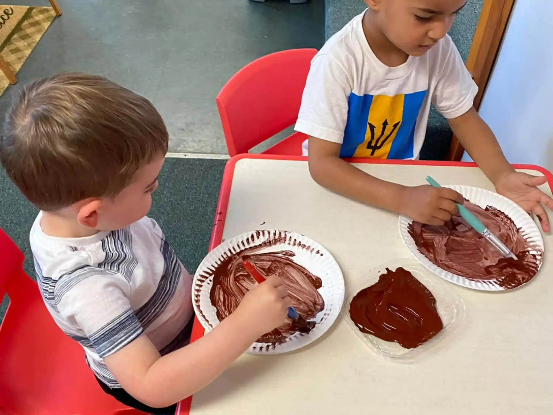 a couple of boys eating cake