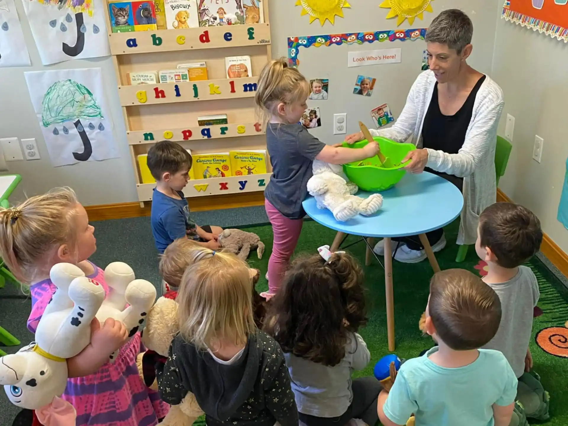 a person and children in a classroom