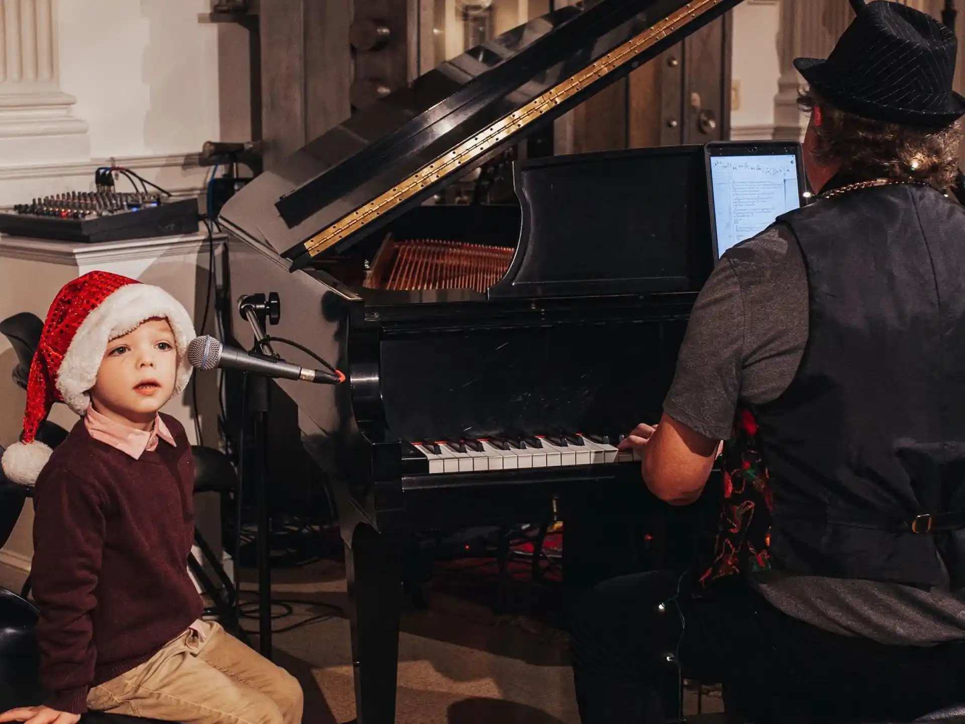 a person and a child playing piano