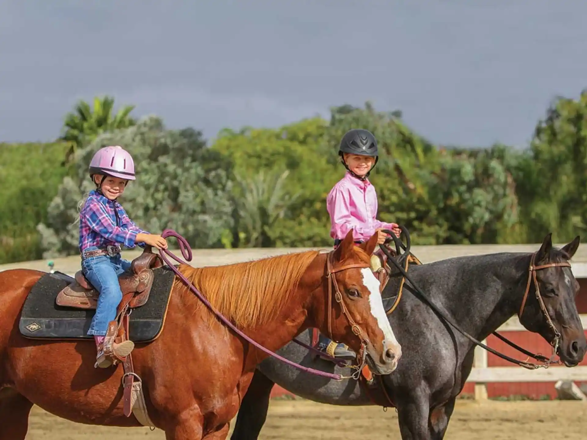a couple of girls riding horses
