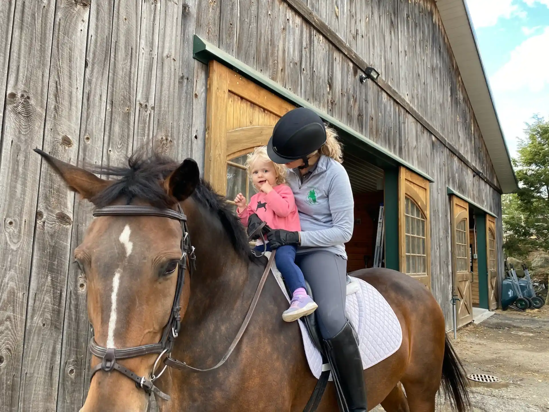 a person and a child riding a horse