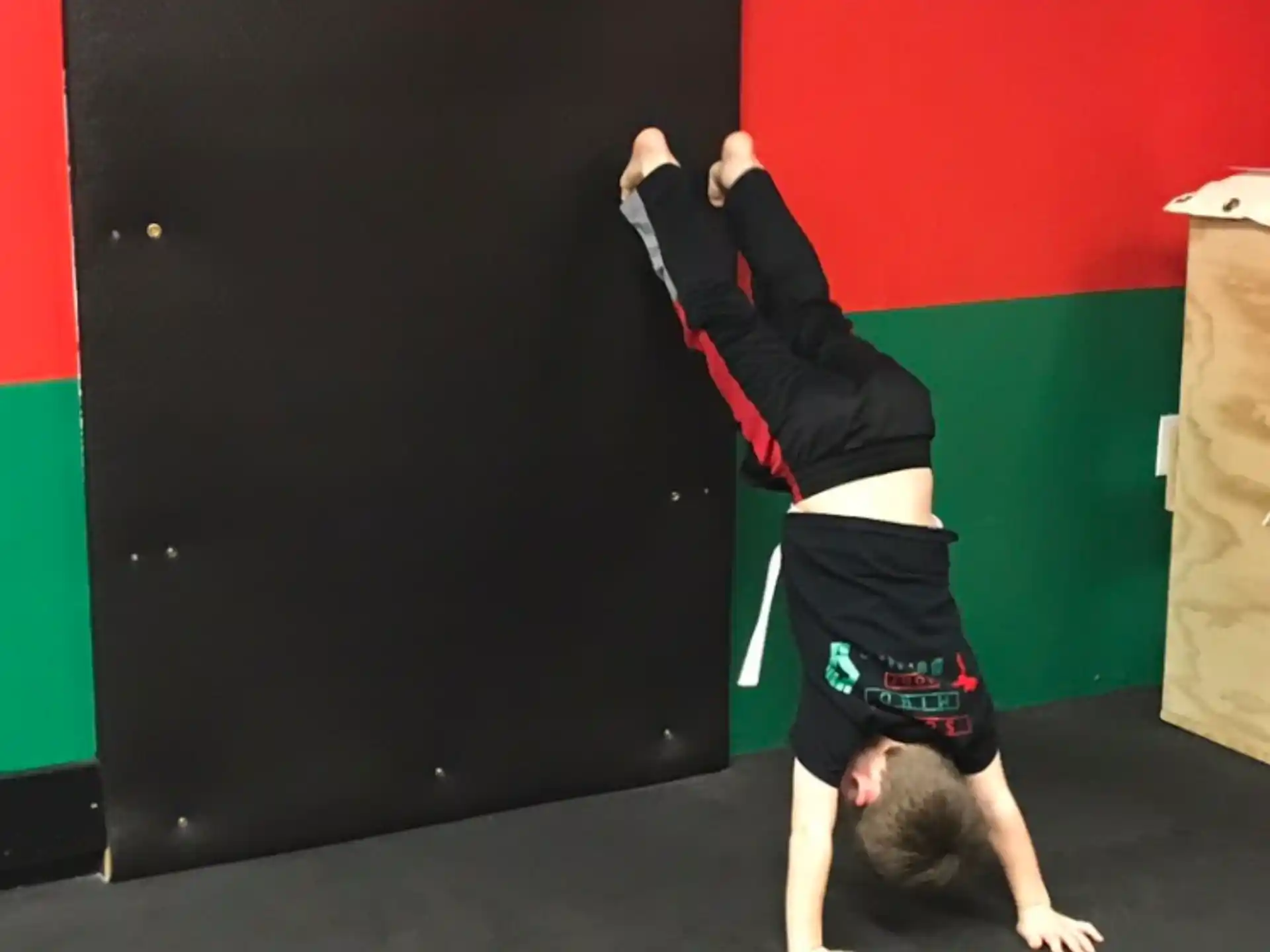 a person doing a handstand on the floor