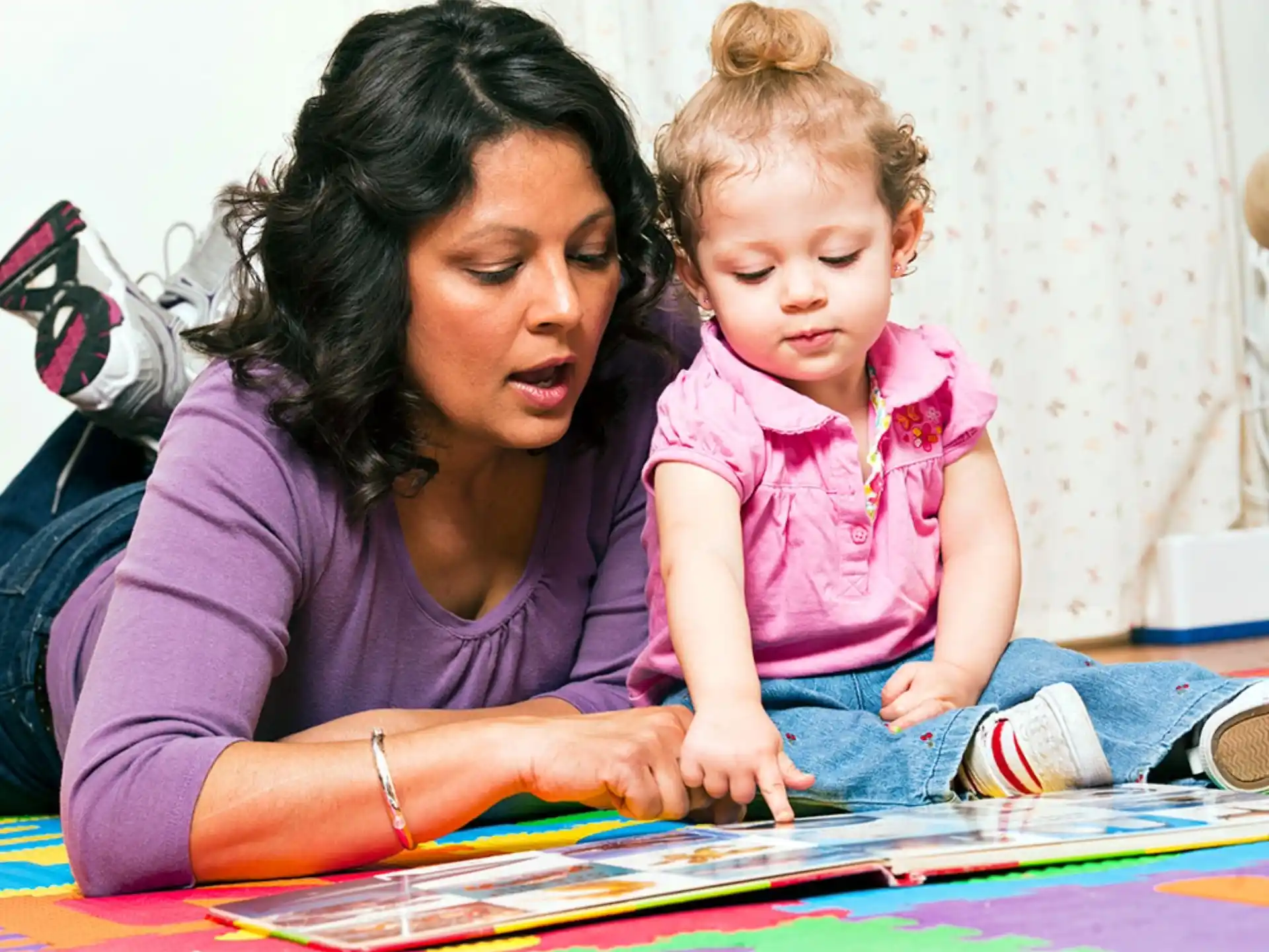 a person and a child playing a board game